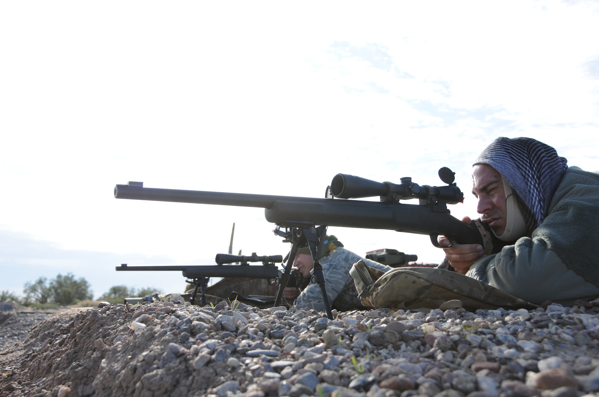 Staff Sgt. Robert Ehle, 161st Security Forces Squadron Advanced Designated Marksmen, hones his newly acquired skills at the shooting range in Florence, Ariz., Jan. 9, 2015. ADM Airmen, or “snipers”, deliver long-range direct fire out to 600 meters and provide enhanced situational awareness through observation and reporting in peacetime and contingency operations. The 161st Security Forces Squadron is one of only eight units of the more than 100 Air National Guard units which currently have trained/qualified advanced designated marksmen. To become a certified Air Force advanced designated marksman, Airmen must attend the ADM course at Ft. Bliss, El Paso, Texas. The 11-day course familiarizes Airmen with the M24 weapon system and teaches target detection, along with distance and windage estimation. “The hardest part of the school is the really long days,” said Ehle. “It’s out in the desert, there’s no shade and it’s about 110 degrees and you are out there for more than eight hours.” (U.S. Air National Guard photo by Tech. Sgt. Courtney Enos/Released)
