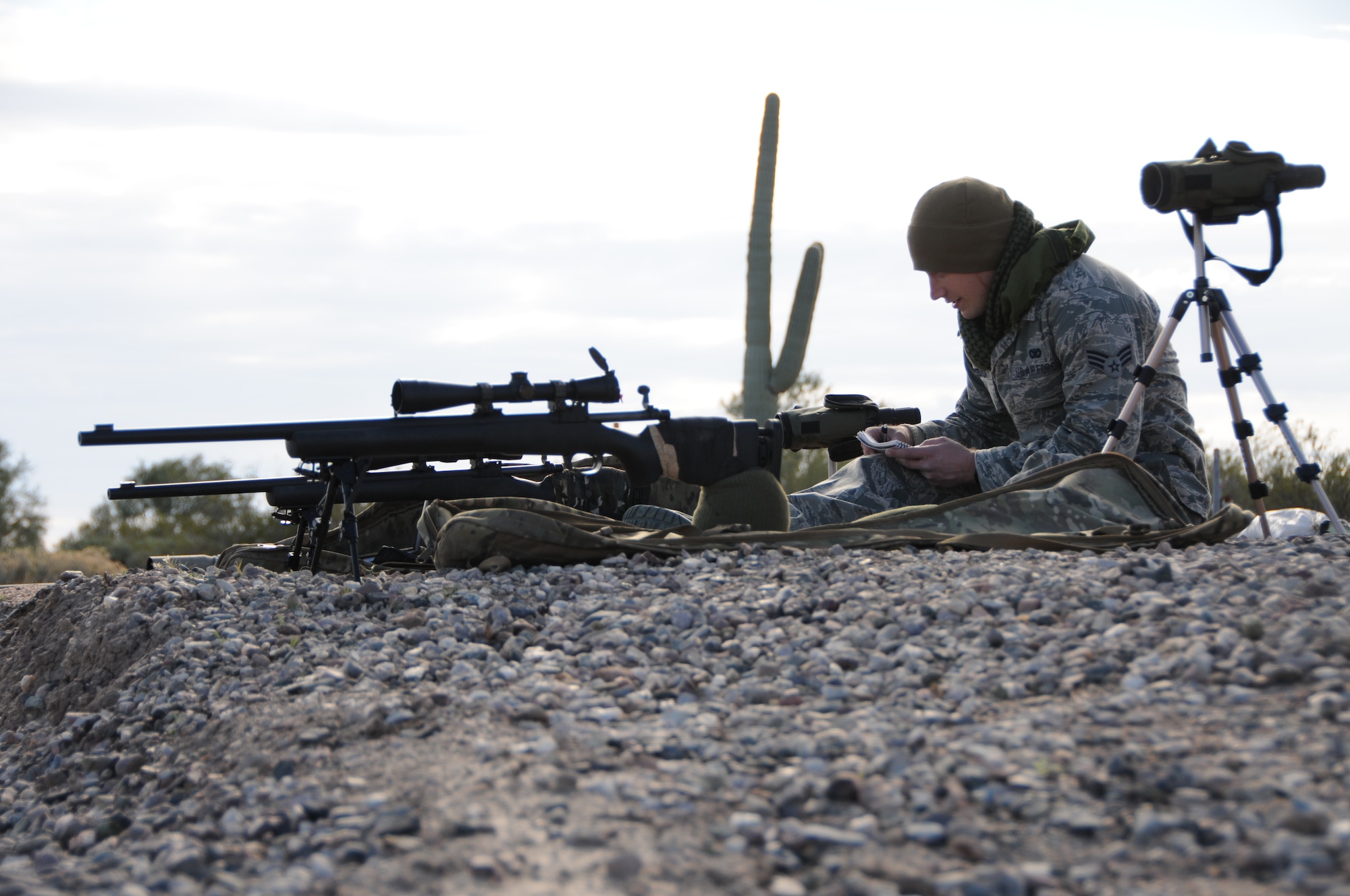(From left to right) Senior Airman Kyle Drzewiecki, 161st Security Forces Squadron Advanced Designated Marksmen, hones his newly acquired skills at the shooting range in Florence, Ariz., Jan. 9, 2015. ADM Airmen, or “snipers”, deliver long-range direct fire out to 600 meters and provide enhanced situational awareness through observation and reporting in peacetime and contingency operations. The 161st Security Forces Squadron is one of only eight units of the more than 100 Air National Guard units which currently have trained/qualified advanced designated marksmen. To become a certified Air Force advanced designated marksman, Airmen must attend the ADM course at Ft. Bliss, El Paso, Texas. The 11-day course familiarizes Airmen with the M24 weapon system and teaches target detection, along with distance and windage estimation. “The hardest part of being an ADM can be the mental aspect,” said Drzewiecki. “You start planning the shot in your mind, which gets your heart rate up and then you’ve got to take the shot; you’ve got to be mentally strong and calm yourself down. You can’t get flustered easily.” (U.S. Air National Guard photo by Tech. Sgt. Courtney Enos/Released)