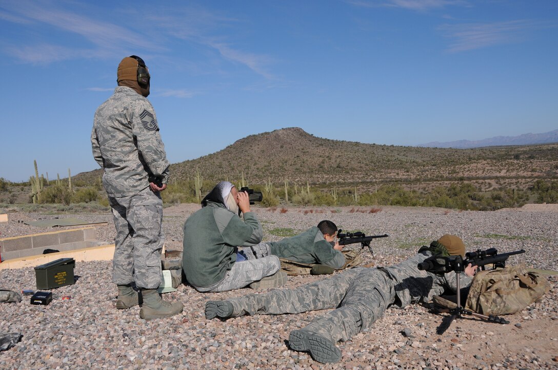 (From left to right) Chief Master Sgt. Emilio Rodriguez, Staff Sgt. Robert Ehle, Tech. Sgt. Frank Calzadillas and Senior Airman Kyle Drzewiecki, Advanced Designated Marksmen from the 161st Security Forces Squadron, hone their newly acquired skills at the shooting range in Florence, Ariz., Jan. 9, 2015. ADM Airmen, or “snipers”, deliver long-range direct fire out to 600 meters and provide enhanced situational awareness through observation and reporting in peacetime and contingency operations. The 161st Security Forces Squadron is one of only eight units of the more than 100 Air National Guard units which currently have trained/qualified advanced designated marksmen. To become a certified Air Force advanced designated marksman, Airmen must attend the ADM course at Ft. Bliss, El Paso, Texas. The 11-day course familiarizes Airmen with the M24 weapon system and teaches target detection, along with distance and windage estimation. (U.S. Air National Guard photo by Tech. Sgt. Courtney Enos/Released)