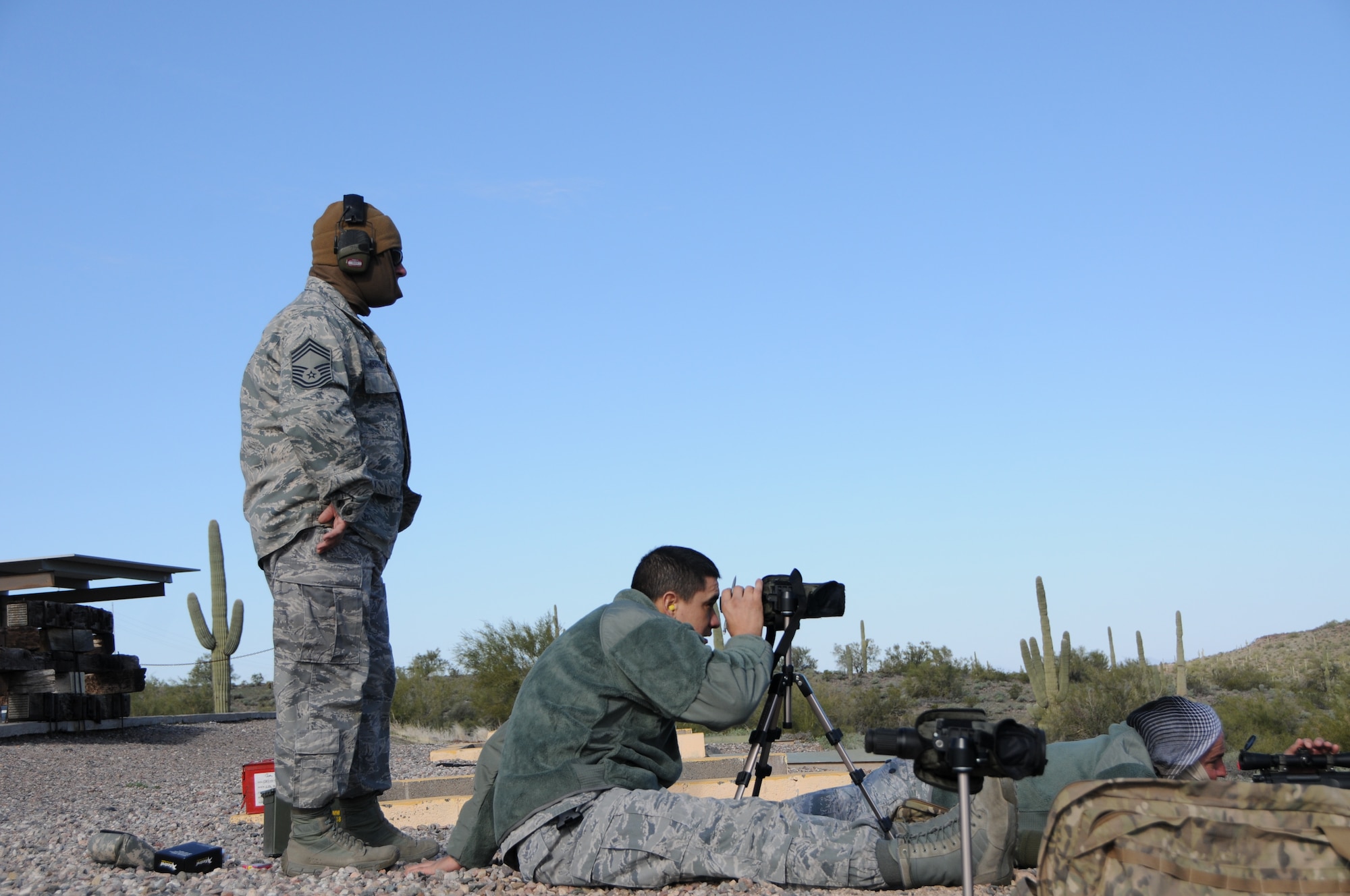 (From left to right) Chief Master Sgt. Emilio Rodriguez, Tech. Sgt. Frank Calzadillas and Staff Sgt. Robert Ehle, Advanced Designated Marksmen from the 161st Security Forces Squadron, hone their newly acquired skills at the shooting range in Florence, Ariz., Jan. 9, 2015. ADM Airmen, or “snipers”, deliver long-range direct fire out to 600 meters and provide enhanced situational awareness through observation and reporting in peacetime and contingency operations. The 161st Security Forces Squadron is one of only eight units of the more than 100 Air National Guard units which currently have trained/qualified advanced designated marksmen. To become a certified Air Force advanced designated marksman, Airmen must attend the ADM course at Ft. Bliss, El Paso, Texas. The 11-day course familiarizes Airmen with the M24 weapon system and teaches target detection, along with distance and windage estimation. (U.S. Air National Guard photo by Tech. Sgt. Courtney Enos/Released)