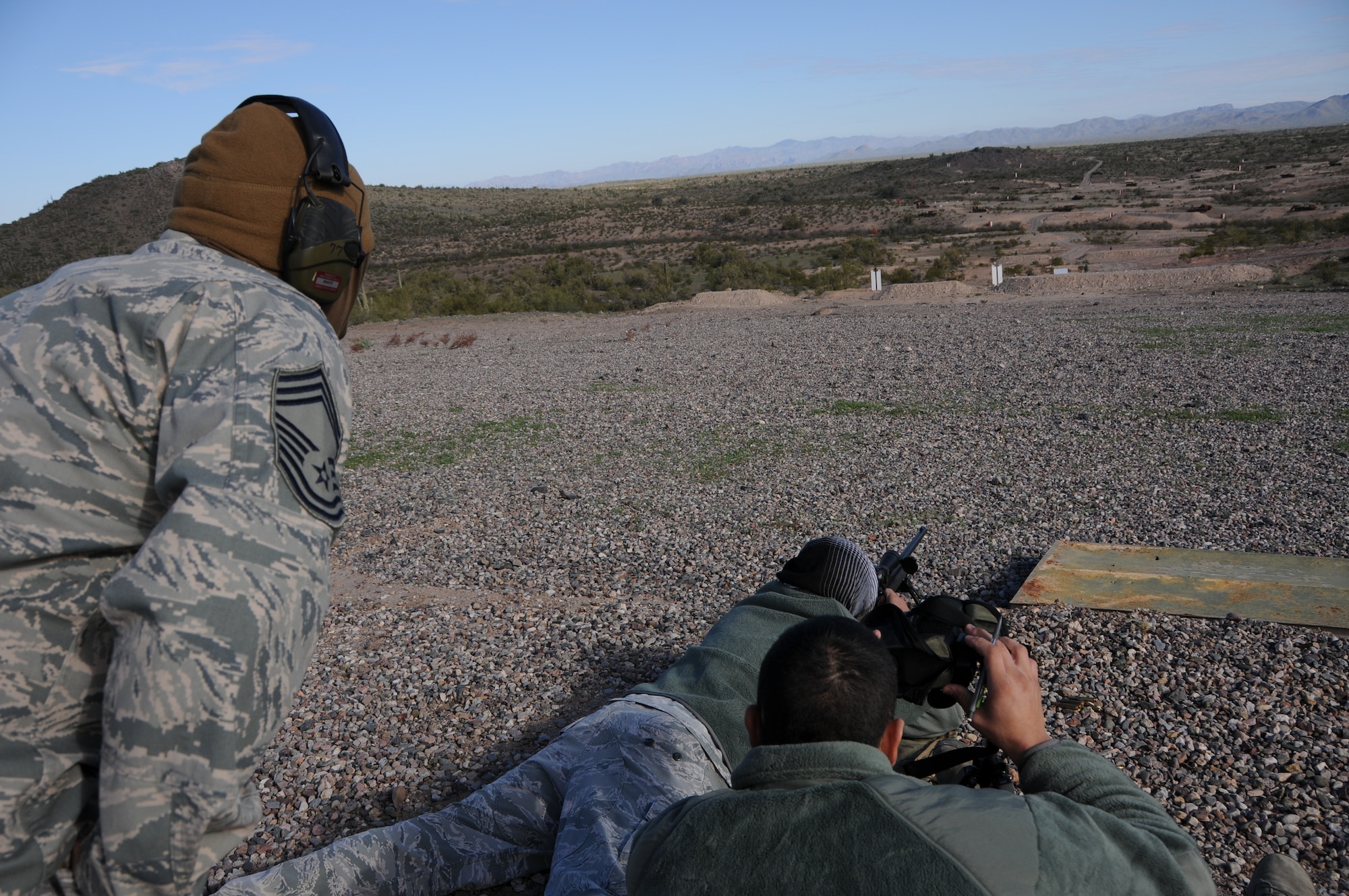 (From left to right) Chief Master Sgt. Emilio Rodriguez, Staff Sgt. Robert Ehle, and Tech. Sgt. Frank Calzadillas, Advanced Designated Marksmen from the 161st Security Forces Squadron, hone their newly acquired skills at the shooting range in Florence, Ariz., Jan. 9, 2015. ADM Airmen, or “snipers”, deliver long-range direct fire out to 600 meters and provide enhanced situational awareness through observation and reporting in peacetime and contingency operations. The 161st Security Forces Squadron is one of only eight units of the more than 100 Air National Guard units which currently have trained/qualified advanced designated marksmen. To become a certified Air Force advanced designated marksman, Airmen must attend the ADM course at Ft. Bliss, El Paso, Texas. The 11-day course familiarizes Airmen with the M24 weapon system and teaches target detection, along with distance and windage estimation. (U.S. Air National Guard photo by Tech. Sgt. Courtney Enos/Released)