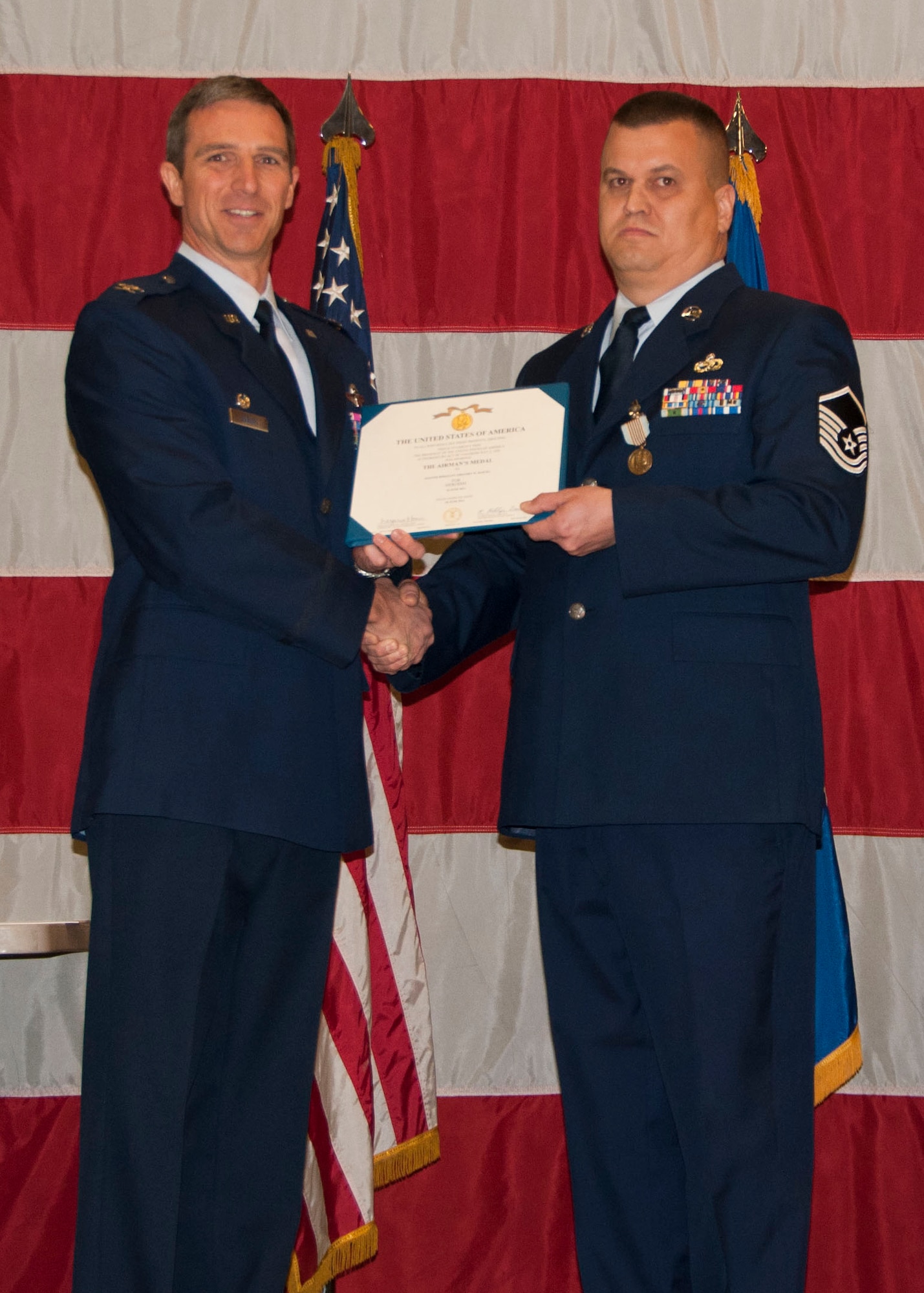 Col. Brayn Radliff, 419th Fighter Wing commander presents Master Sgt. Gregory Bartel with the Airman’s Medal for his act of heroism here today. (U.S. Air Force photo/Capt. Amber Balken)