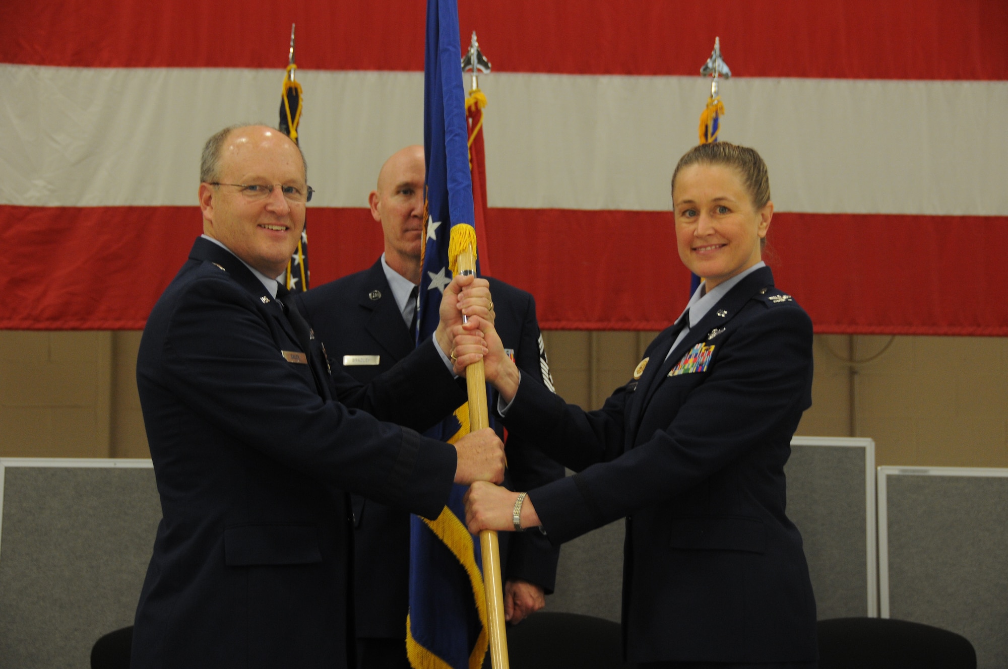 Col. Bobbi Doorenbos accepts the guidon from Brig. Gen. Travis Balch, commander of the Air National Guard, during a change of command ceremony held at Ebbing Air National Guard Base, Fort Smith, Ark., Jan. 11, 2015. Doorenbos, former commander of the 214th Reconnaissance Group, assumed command of the 188th Wing from Col. Mark Anderson. (U.S. Air National Guard photo by Airman 1st Class Cody Martin/released)