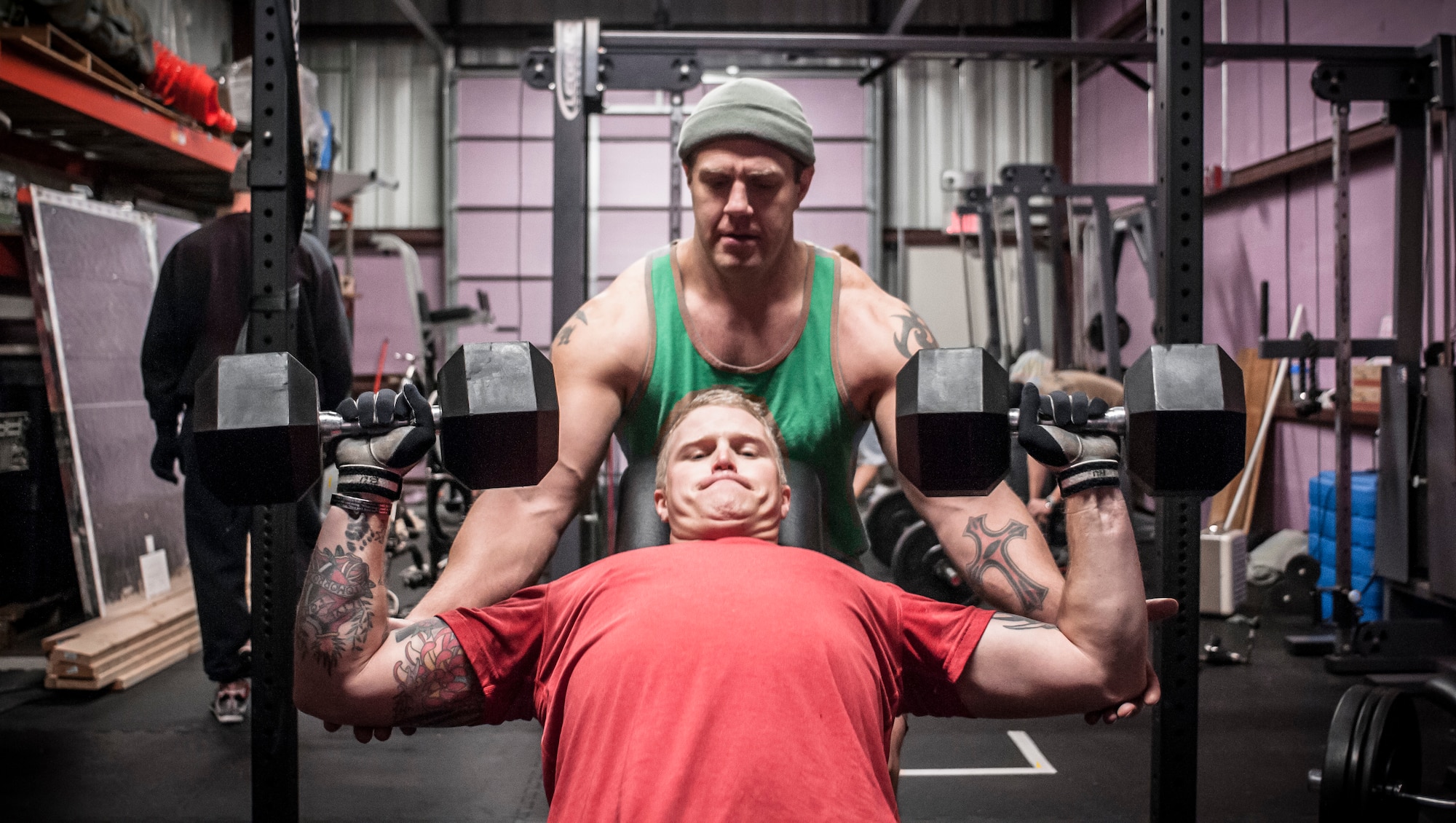 Technical Sgt. Michael Belleau performs an incline dumbbell press as Master Sgt. Jonathan Oliver spots and encourages him during a weighted press. Both Airman from the 169th Air Support Operations Squadron, Peoria, IL, train together on a regular basis to maintain a high fitness requirement there career field requires on January 10, 2015. As Joint Terminal Attack Controllers the demanding job needs each airman to perform at peak performance alongside their Army counterparts out in the field. Besides the fitness benefits the members are getting teamwork, camaraderie and morale building are big advantages they are creating. They are building physical strength but more importantly the strength of teamwork to take to the battlefield. (U.S. Air National Guard photo by Master Sgt. Scott Thompson/released)