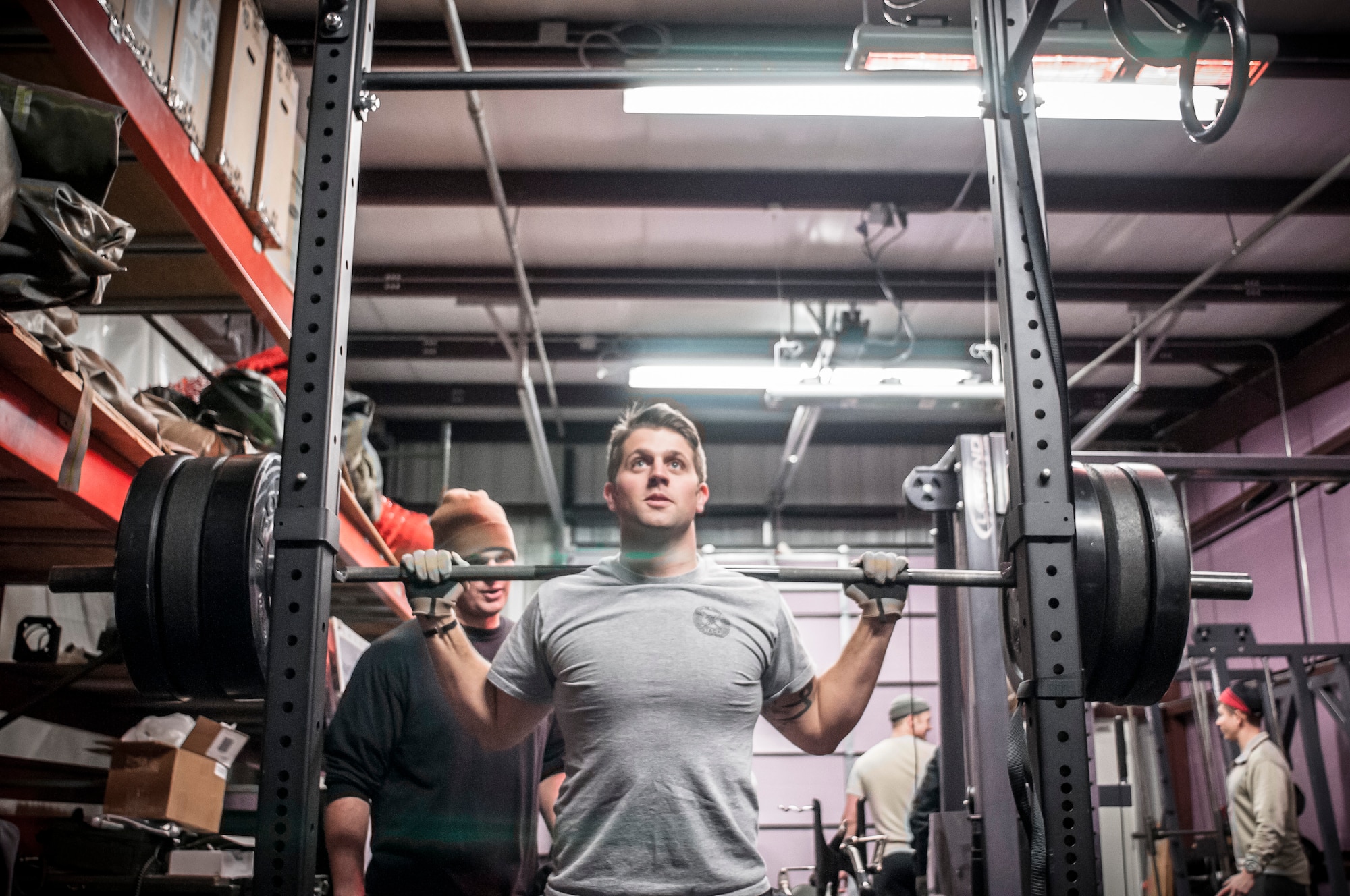 Staff Sgt. Cody Canfield gets set for a back squat as Staff Sgt. Matthew Denault helps encourage and spots him during a weighted lift. Both Airman from the 169th Air Support Operations Squadron, Peoria, IL, train together on a regular basis to maintain a high fitness requirement there career field requires on January 10, 2015. As Joint Terminal Attack Controllers the demanding job needs each airman to perform at peak performance alongside their Army counterparts out in the field. Besides the fitness benefits the members are getting teamwork, camaraderie and morale building are big advantages they are creating. They are building physical strength but more importantly the strength of teamwork to take to the battlefield.(U.S. Air National Guard photo by Master Sgt. Scott Thompson/released)