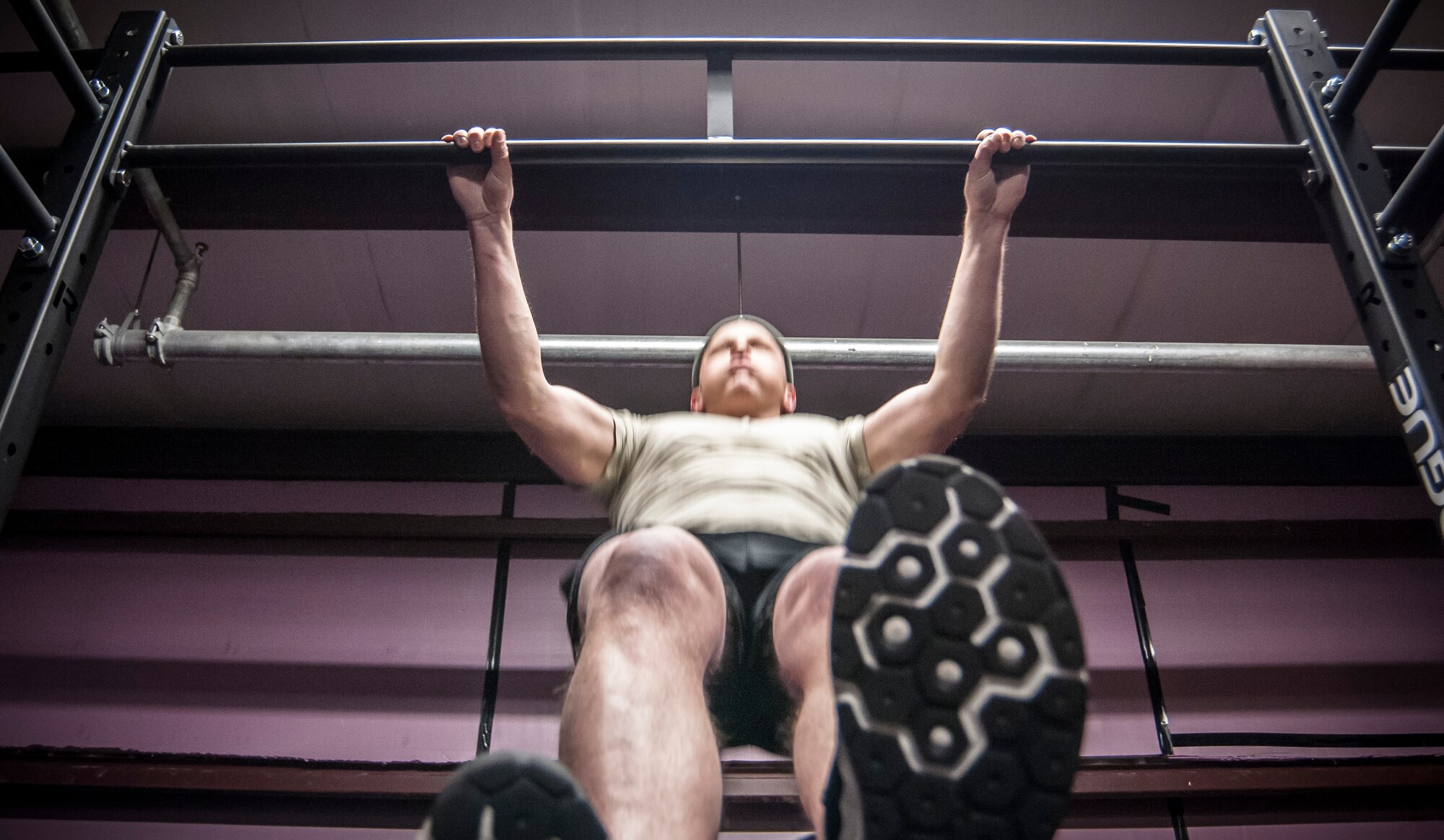 Staff Sgt. Nicholas Menz performs chest to bar pull ups in a team crossfit workout. Both Airman from the 169th Air Support Operations Squadron, Peoria, IL, train together on a regular basis to maintain a high fitness requirement there career field requires on January 10, 2015. As Joint Terminal Attack Controllers the demanding job needs each airman to perform at peak performance alongside their Army counterparts out in the field. Besides the fitness benefits the members are getting teamwork, camaraderie and morale building are big advantages they are creating. They are building physical strength but more importantly the strength of teamwork to take to the battlefield. (U.S. Air National Guard photo by Master Sgt. Scott Thompson/released)