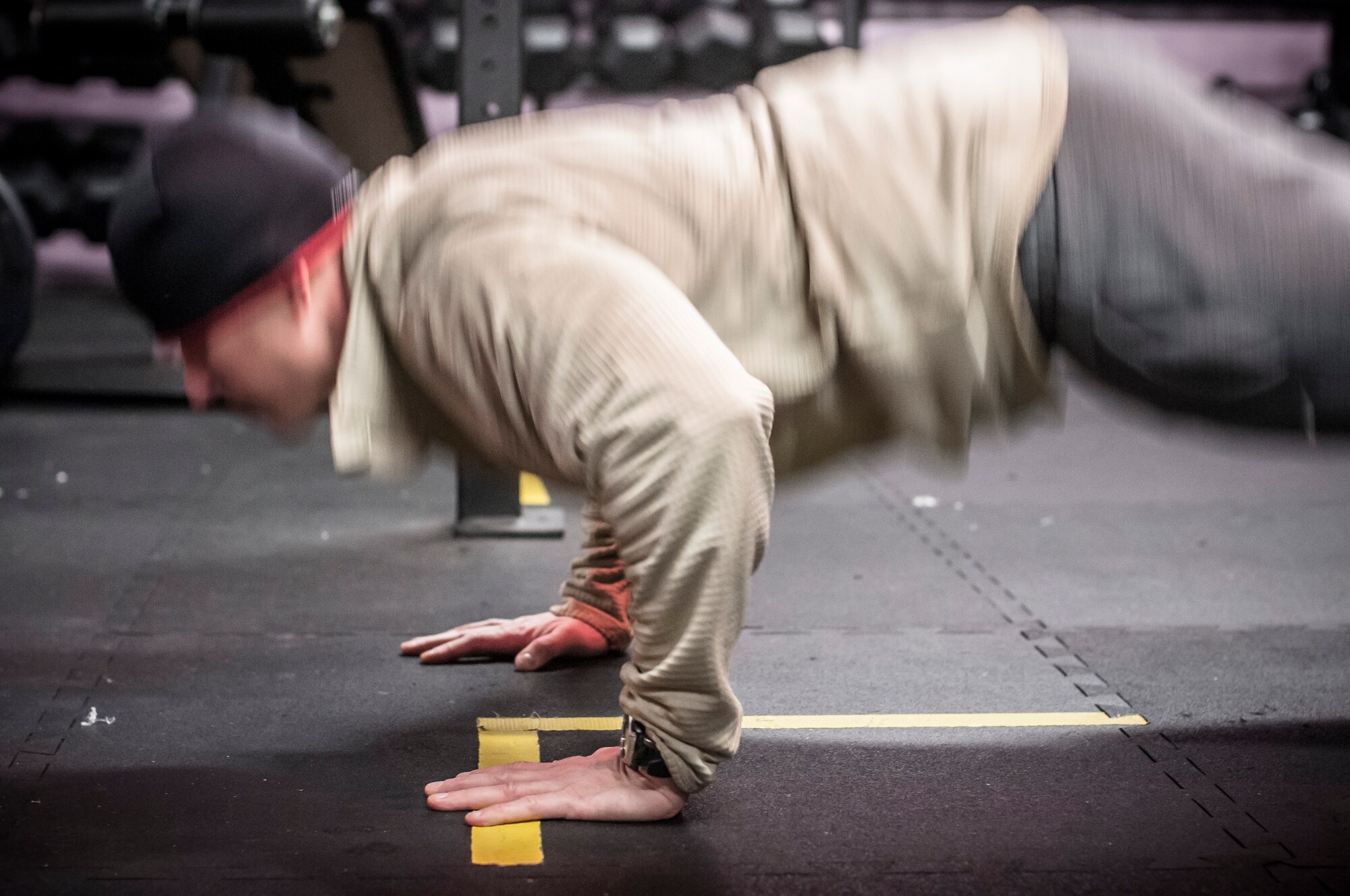 Capt. Daniel Curtin conducts burpees as part of a team crossfit workout. Both Airman from the 169th Air Support Operations Squadron, Peoria, IL, train together on a regular basis to maintain a high fitness requirement there career field requires on January 10, 2015. As Joint Terminal Attack Controllers the demanding job needs each airman to perform at peak performance alongside their Army counterparts out in the field. Besides the fitness benefits the members are getting teamwork, camaraderie and morale building are big advantages they are creating. They are building physical strength but more importantly the strength of teamwork to take to the battlefield. (U.S. Air National Guard photo by Master Sgt. Scott Thompson/released)