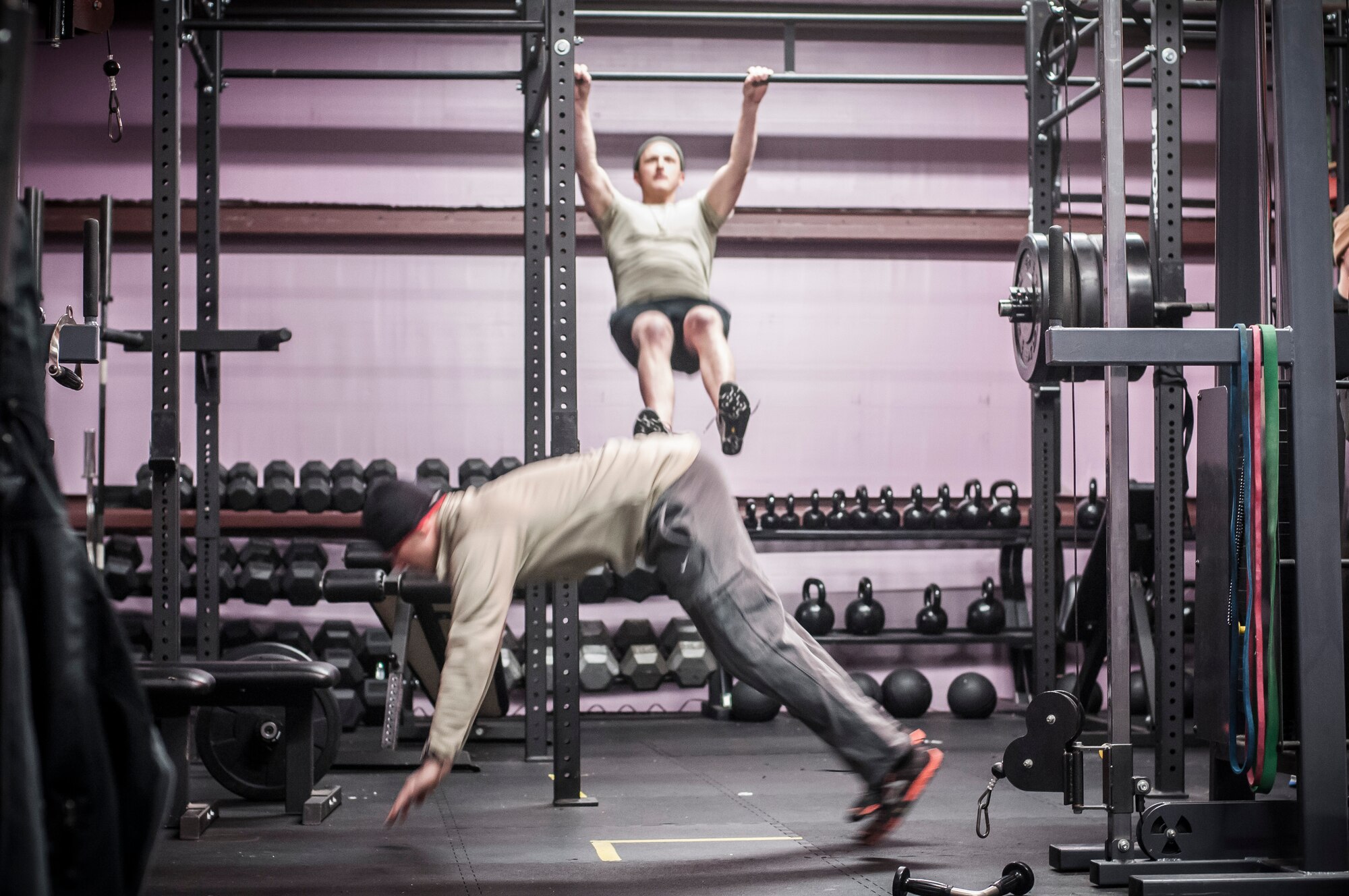 Staff Sgt. Nicholas Menz performs chest to bar pull ups as Capt. Daniel Curtin conducts burpees as a team croosfit workout. Both Airman from the 169th Air Support Operations Squadron, Peoria, IL, train together on a regular basis to maintain a high fitness requirement there career field requires on January 10, 2015. As Joint Terminal Attack Controllers the demanding job needs each airman to perform at peak performance alongside their Army counterparts out in the field. Besides the fitness benefits the members are getting teamwork, camaraderie and morale building are big advantages they are creating. They are building physical strength but more importantly the strength of teamwork to take to the battlefield. (U.S. Air National Guard photo by Master Sgt. Scott Thompson/released)