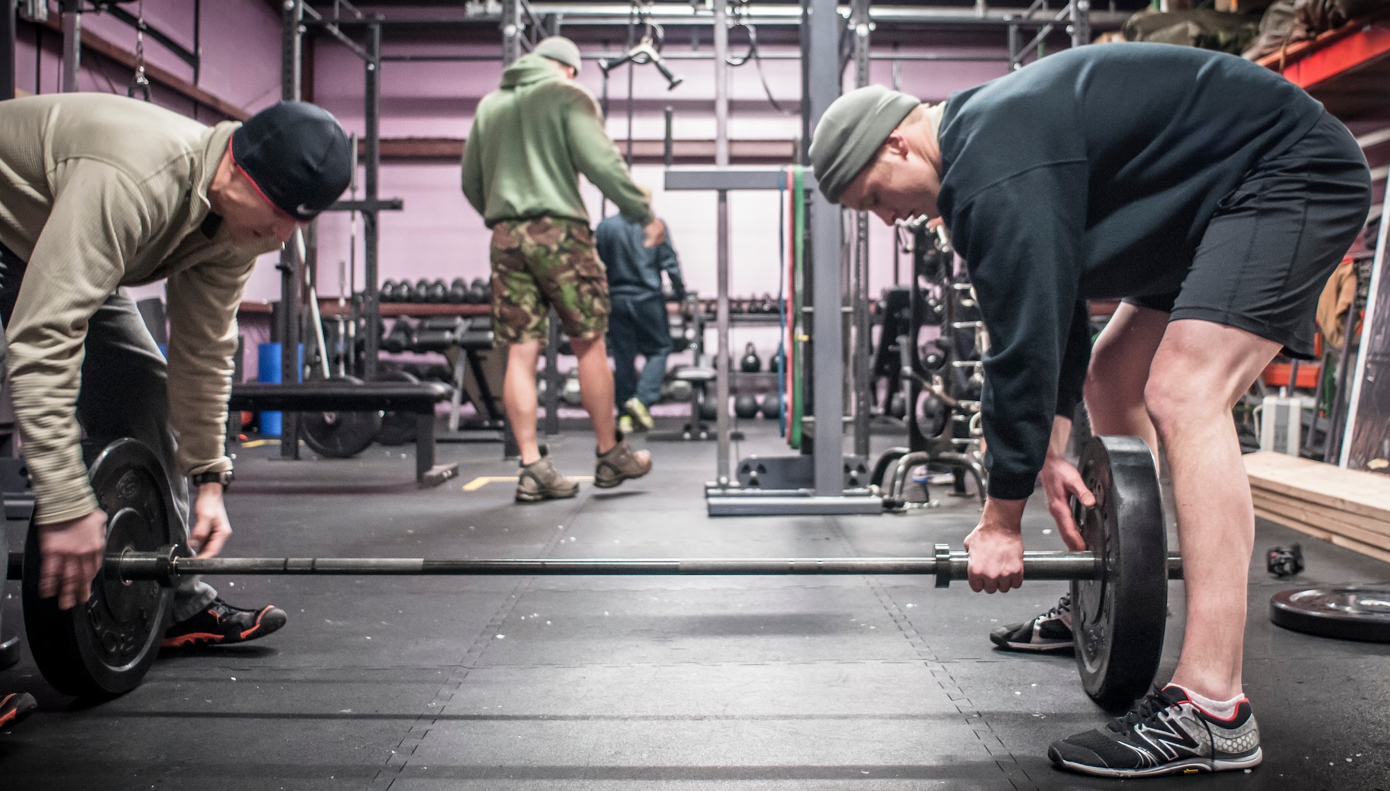 Capt. Daniel Curtin (left) and Staff Sgt. Nicholas Menzto switch out more weight prior to another repetition of the overhead squat. Both Airman from the 169th Air Support Operations Squadron, Peoria, IL, train together on a regular basis to maintain a high fitness requirement there career field requires on January 10, 2015. As Joint Terminal Attack Controllers the demanding job needs each airman to perform at peak performance alongside their Army counterparts out in the field. Besides the fitness benefits the members are getting teamwork, camaraderie and morale building are big advantages they are creating. They are building physical strength but more importantly the strength of teamwork to take to the battlefield. (U.S. Air National Guard photo by Master Sgt. Scott Thompson/released)