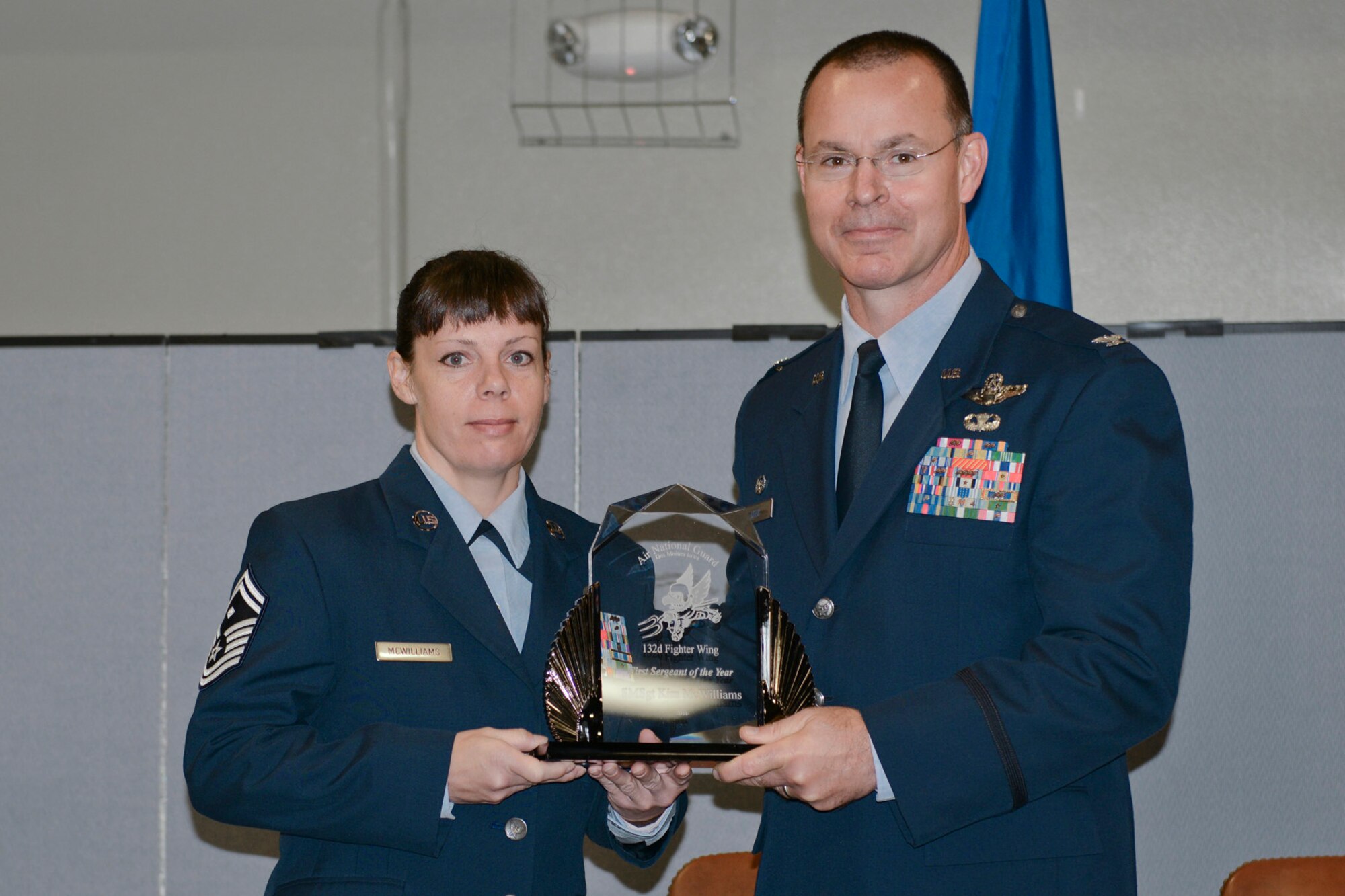 Col. Kevin Heer (right), Commander, 132nd Fighter Wing (132FW), Des Moines, Iowa, presents Senior Master Sgt. Kimberly McWilliams (left) with the 132FW First Sergeant of the Year award at the 2014 Annual Awards Ceremony held at the Valley Community Center, West Des Moines, Iowa on Saturday, November 1, 2014.  Senior Master Sgt. McWilliams has since been selected as the 2015 Iowa ANG Outstanding First Sergeant of the Year.  (U.S. Air National Guard photo by Staff Sgt. Linda K. Burger/Released)