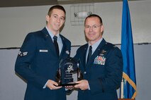 Col. Kevin Heer (right), Commander, 132nd Fighter Wing, Des Moines, Iowa, presents Senior Airman Jonathan Green (left) with the Airman of the Year award at the 2014 Annual Awards Ceremony held at the Valley Community Center, West Des Moines, Iowa on Saturday, November 1, 2014.  (U.S. Air National Guard photo by Staff Sgt. Linda K. Burger/Released)