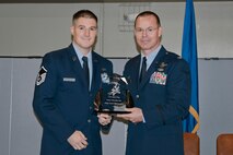 Col. Kevin Heer (right), Commander, 132nd Fighter Wing (132FW), Des Moines, Iowa, presents Master Sgt. Aaron McConeghey (left) with the 132FW Senior NCO of the Year award at the 2014 Annual Awards Ceremony held at the Valley Community Center, West Des Moines, Iowa on Saturday, November 1, 2014.  Master Sgt. McConeghey has since been selected as the 2015 Iowa ANG Outstanding Senior NCO of the Year.  (U.S. Air National Guard photo by Staff Sgt. Linda K. Burger/Released)