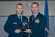 Col. Kevin Heer (right), Commander, 132nd Fighter Wing, Des Moines, Iowa, presents Capt. Brandon Cochran (left) with the Officer of the Year award at the 2014 Annual Awards Ceremony held at the Valley Community Center, West Des Moines, Iowa on Saturday, November 1, 2014.  (U.S. Air National Guard photo by Staff Sgt. Linda K. Burger/Released)