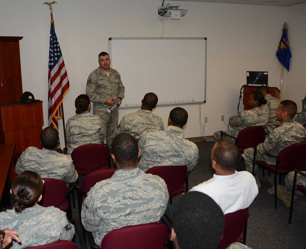 Tech. Sgt. Jose Rodriguez, 433rd Training Squadron, Joint Base San Antonio-Lackland, Texas, speaks to 512th Airlift Wing reservists about the professional growth opportunities he acquired from his role as a military training instructor, Jan. 11, 2015 at Dover Air Force Base, Del. The 433rd TRS is seeking qualified reservists to fill approximately 30 MTI vacancies. (U. S. Air Force photo by Senior Airman Joe Yanik)