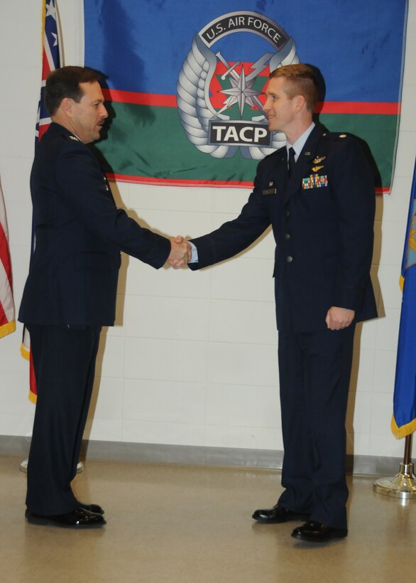U.S. Air Force Col. Mike Nabors, commander of the 186th Air Refueling Wing, congratulates U. S. Air Force Lt. Col. Britt Watson, incoming commander of the 238th Air Support Operations Squadron (ASOS), on Key Field Air National Guard Base, Jan. 10, 2015. Watson assumed command of the 238th ASOS during an assumption of command ceremony. (U. S. Air National Guard Photo by Tech. Sgt. Richard L. Smith/Released)