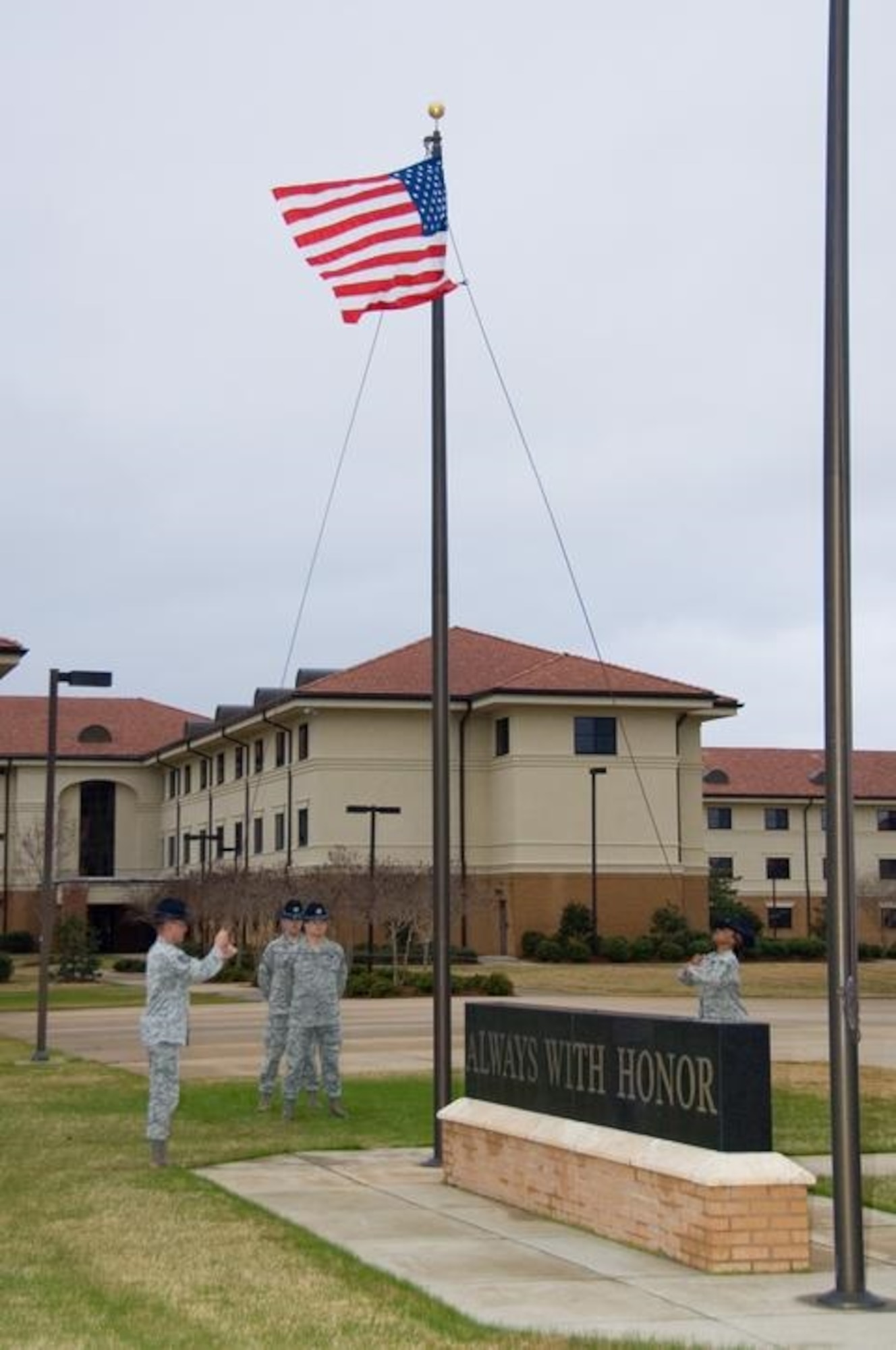 U.S. Air Force training instructors lower the American flag during a retreat ceremony for the Officer Training School's 50th Anniversary weekend celebration at Welch parade field on Maxwell-Gunter Air Force Base, Ala., Feb 5, 2010. (U.S. Air Force photo by Melanie Rodgers Cox/Released)