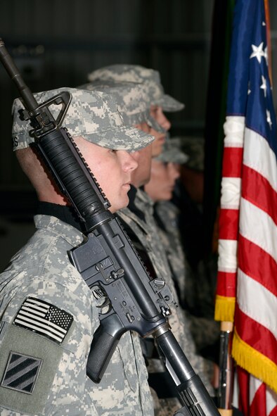 Members of the U.S. Army Color Guard prepare to post the colors during the Saint Barbara’s Day celebration at an undisclosed location in Southwest Asia Dec. 20, 2014. The Honorable Order of Saint Barbara recognizes those individuals who have demonstrated the highest standards of integrity and moral character and displayed an outstanding degree of professional competence. (U.S. Air Force photo/Tech. Sgt. Marie Brown)