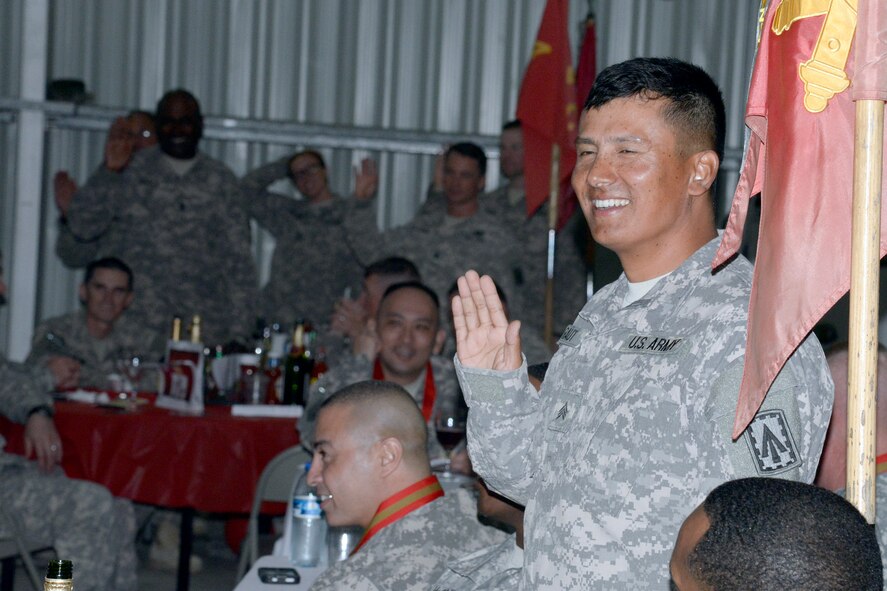 Non-artillerymen take an oath of secrecy during the Saint Barbara’s Day celebration at an undisclosed location in Southwest Asia Dec. 20, 2014. More than 150 Soldiers assembled into the Phantom Center here to celebrate Saint Barbara's Day, hosted by the 3rd Battalion, 4th Air Defense Artillery Regiment. (U.S. Air Force photo/Tech. Sgt. Marie Brown)