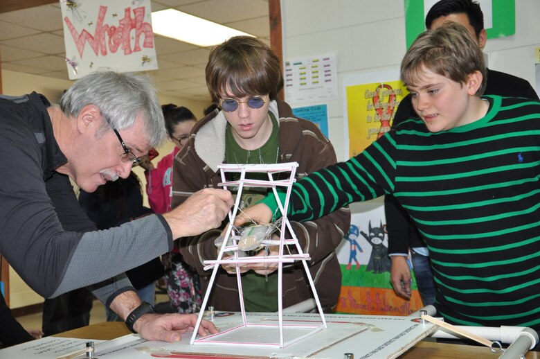 Doug Bliss (left), geotechnical and environmental engineering branch chief at the Far East District, helps Tristen Henley (center) and Jack Donoghe, eight grade students at Seoul American Middle School, during the earthquake tower challenge Jan. 9.

