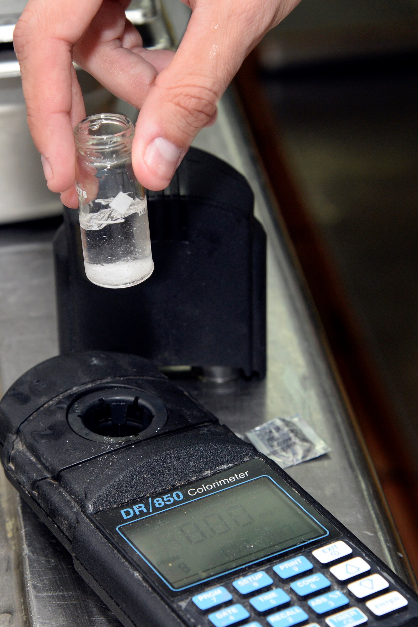 Staff Sgt. Dennis, bioenvironmental engineering technician, prepares a water sample to test the chlorine level using a Colorimeter at an undisclosed location in Southwest Asia Dec. 24, 2014. Water is tested to make sure the water is safe for consumption. Dennis is currently deployed from Joint Base San Antonio, Texas and is a native of San Antonio, Texas. (U.S. Air Force photo/Tech. Sgt. Marie Brown)