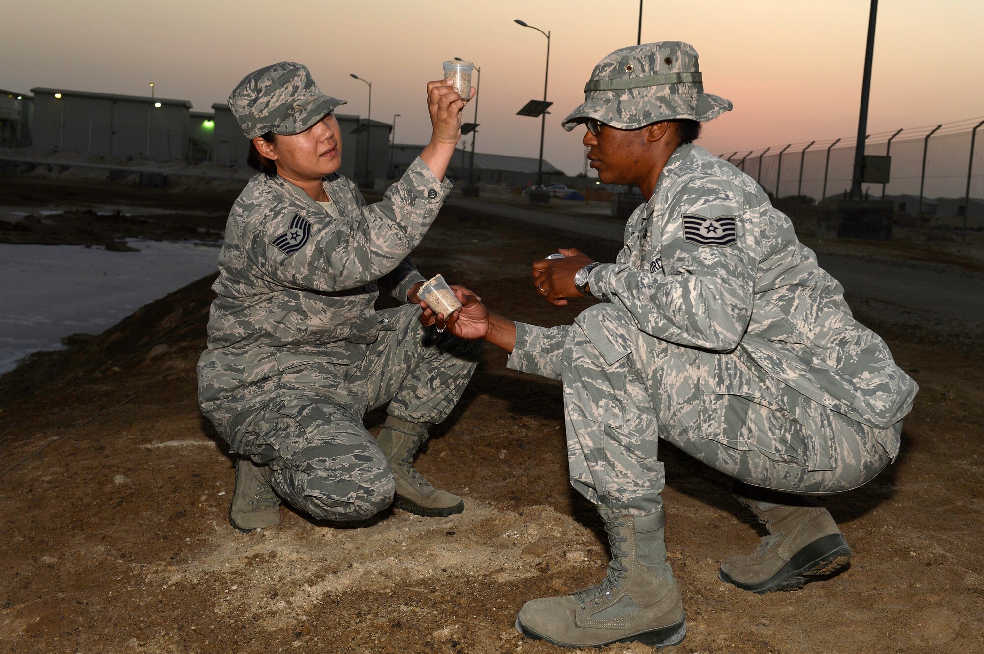 Tech. Sgt. Jenn, left, public health technician, and Tech. Sgt. Margaret, bioenvironmental engineering NCO in-charge, collect soil samples at an undisclosed location in Southwest Asia Dec. 24, 2014. Members of public health and bioenvironmental engineering make up the Preventive Medicine clinic, which are committed to keeping every Airman free of illness and injury. Jenn is currently deployed from Offut Air Force Base, Neb., and is a native of Vallejo, Calif. Margaret is currently deployed from Nellis Air Force Base, Nev., and is a native of Chicago, Ill. (U.S. Air Force photo/Tech. Sgt. Marie Brown)