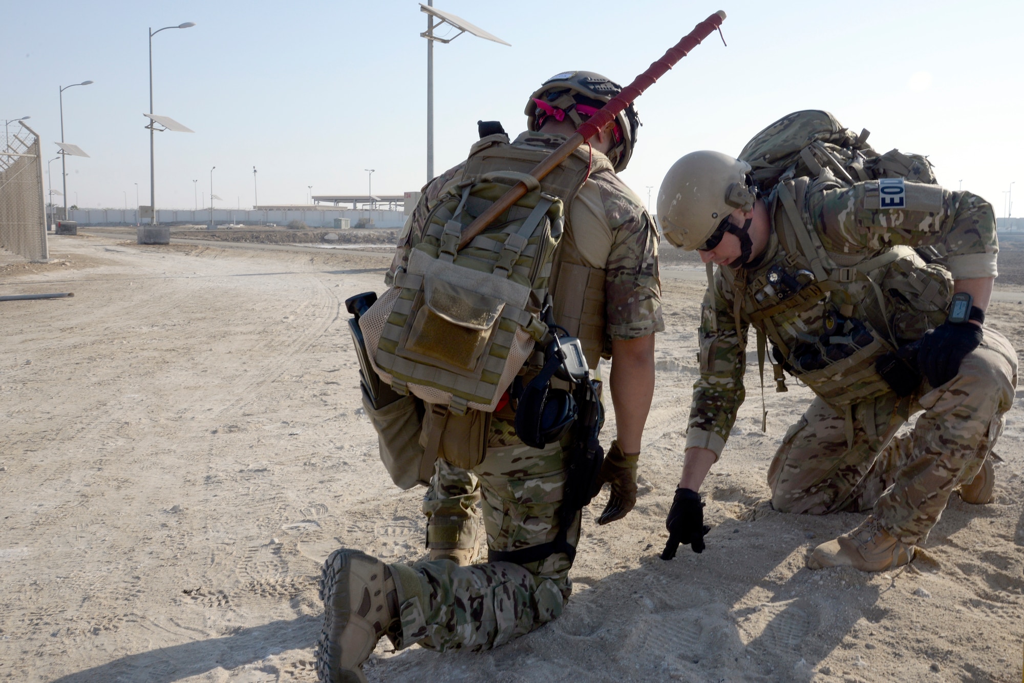 Staff Sgt. Ace, right, and Senior Airman Paola, explosive ordnance disposal technicians, strategize their movement while on foot patrol during a training exercise at an undisclosed location in Southwest Asia Dec. 30, 2014. Airmen who work in the EOD flight are required to think outside the box and accept nothing less than perfection when performing their duties. Ace is currently deployed from Joint Base Elmendorf-Richardson, Ala., and Paola is currently deployed from Fairchild Air Force Base, Wash. (U.S. Air Force photo/Tech. Sgt. Marie Brown)
