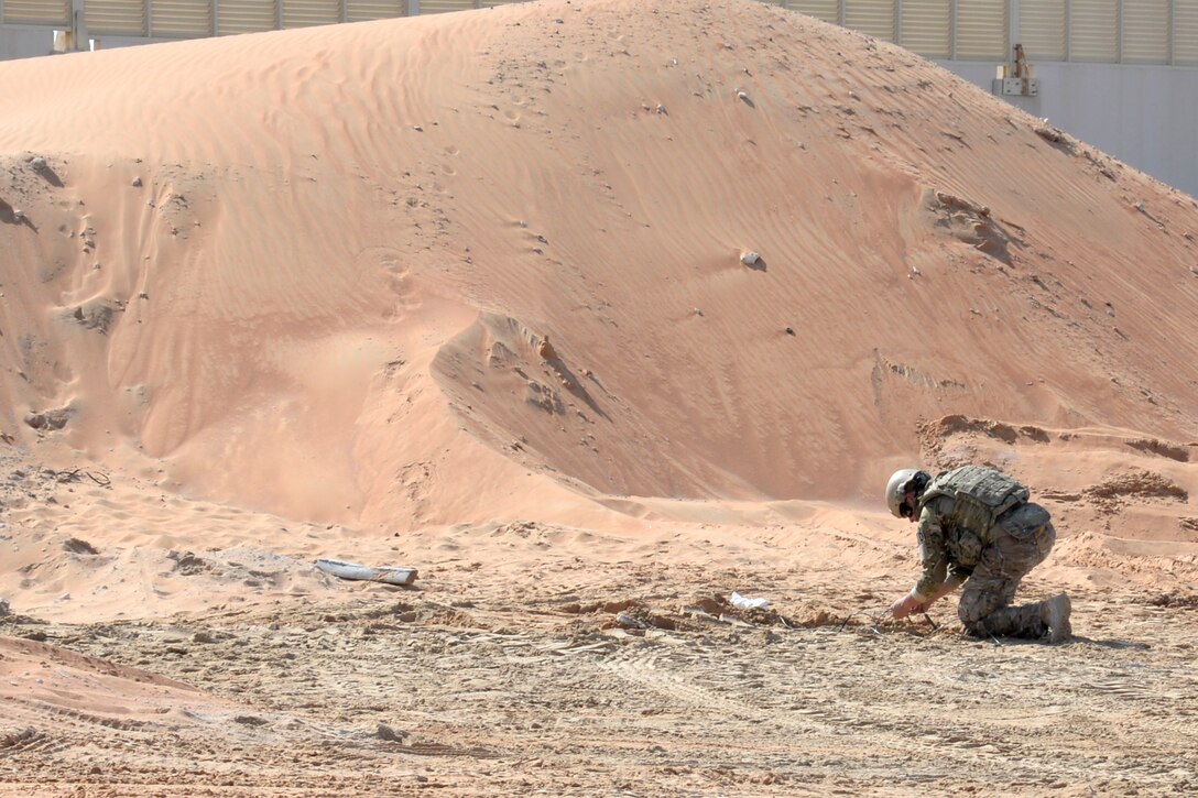 Staff Sgt. Ace, explosive ordnance disposal technician, prepares a simulated improvised explosive device for detonation during a training exercise at an undisclosed location in Southwest Asia Dec. 30, 2014. EOD Airmen are tasked with clearing munitions and enabling base operations to resume, such as clearing the airfield and creating an airstrip to get aircraft back in the air in order to provide air superiority. Ace is currently deployed from Joint Base Elmendorf-Richardson, Ala. (U.S. Air Force photo/Tech. Sgt. Marie Brown)