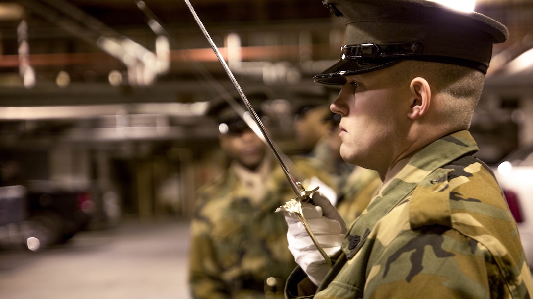United States Marines practice sword manual during Ceremonial Drill School at Marine Barracks Washington, D.C., Jan. 8, 2015 Marine Barracks Washington, D.C. The school teaches officers and staff noncommissioned officers of the Barracks their part in preparation for parade season.