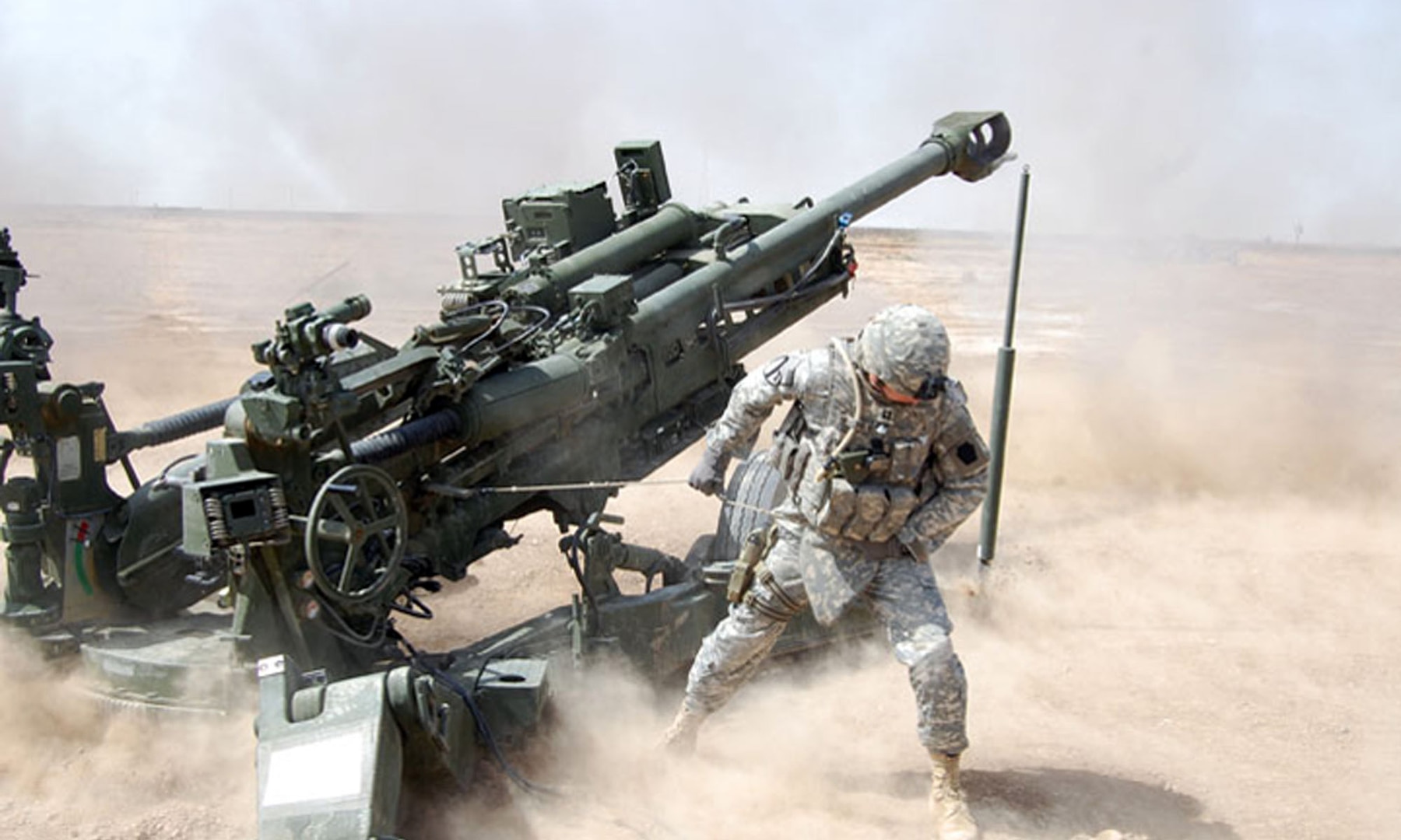 Members of B Battery calibrate the M777A2 in Iraq in March 2009, ensuring the weapon's accuracy and "dusting off the cobwebs" by re-familiarizing themselves with the howitzer.