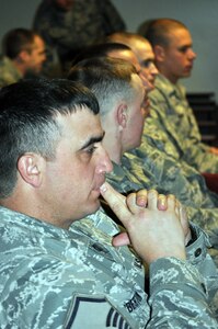 Oregon Air National Guard, Master Sgt. Cody Pemberton, 173rd Fighter Wing Security Forces, from Kingsfield, Ore. listens intently to the Joint Reception Staging Onward Movement Integration briefing given by the Alaska National Guard prior to his unit's arrival to Alaska April 21 to participate in Vigilant Guard 2010. Vigilant Guard is a premiere joint training exercise designed to increase inter-operability among state, federal , local and volunteer agencies in case of a disaster.