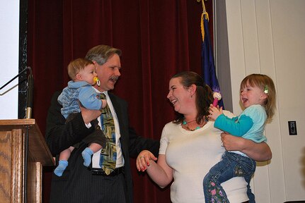 North Dakota Gov. John Hoeven welcomes Jennifer Vannurden and daughter, Alaina, while holding Vannurden's son, Mark, before signing the Month of the Military Child proclamation at the North Dakota State Capitol building in Bismarck, N.D., April 22, 2010. Jennifer's husband, Capt. Walyn Vannurden, is currently deployed to Afghanistan as the commander of the North Dakota National Guard's 188th Air Defense Artillery Rapid Aerostat Initial Deployment (RAID) IV.