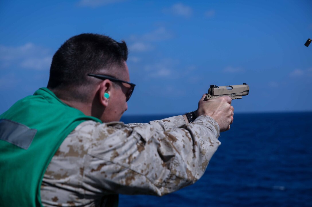 U.S. Marine Corps Lt. Col. Christopher DeAntoni, operations officer, 11th Marine Expeditionary Unit (MEU), engages his target as part of a pistol range aboard the amphibious assault ship USS Makin Island (LHD 8), Jan. 8, 2014. The 11th MEU is deployed with Makin Island Amphibious Ready Group as a theater reserve and crisis response force throughout U.S. Central Command and 5th Fleet area of responsibility. (U.S. Marine Corps photo by Cpl. Evan R. White/Released)