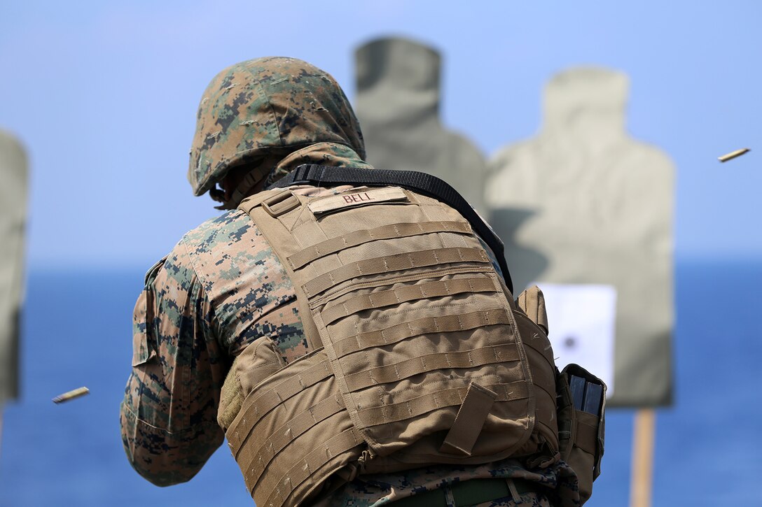 Lance Cpl. Robin Bell, a warehouse clerk with Combat Logistics Battalion 11, 11th Marine Expeditionary Unit (MEU), from Lauderhill, Florida, engages a target during an advanced combat marksmanship program shoot on the flight deck of the dock landing ship USS Comstock (LSD 45), Jan. 9. The 11th MEU is deployed with the Makin Island Amphibious Ready Group (ARG) as a theater reserve and crisis response force throughout the U.S. 5th Fleet and U.S. 7th Fleet areas of responsibility.  (U.S. Marine Corps photo by Sgt. Melissa Wenger/Released)