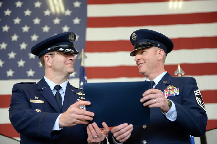 Col. Darren Halford, 9th Operations Group commander (left), presents Chief Master Sgt. James Crites, 9th Operations Group superintendent, his retirement certificate during his retirement ceremony at Beale Air Force Base, Calif., Jan. 9, 2015. Crites served as the senior advisor to the commander regarding matters concerning morale, health and welfare, effective utilization and professional development of the groups enlisted force. (U.S. Air Force photo by Senior Airman Bobby Cummings/Released)