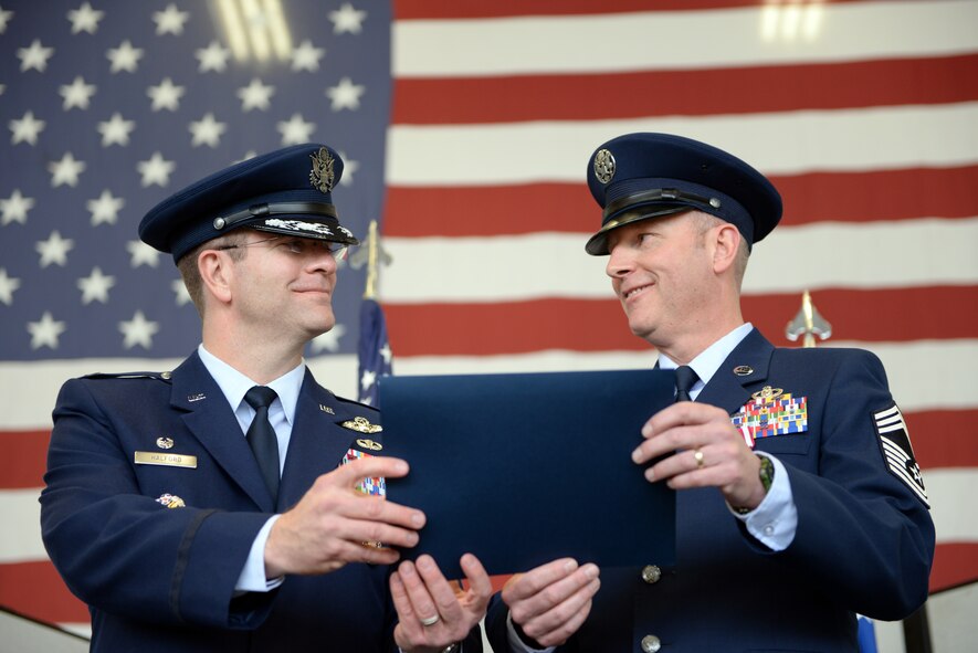 Col. Darren Halford, 9th Operations Group commander (left), presents Chief Master Sgt. James Crites, 9th Operations Group superintendent, his retirement certificate during his retirement ceremony at Beale Air Force Base, Calif., Jan. 9, 2015. Crites served as the senior advisor to the commander regarding matters concerning morale, health and welfare, effective utilization and professional development of the groups enlisted force. (U.S. Air Force photo by Senior Airman Bobby Cummings/Released)