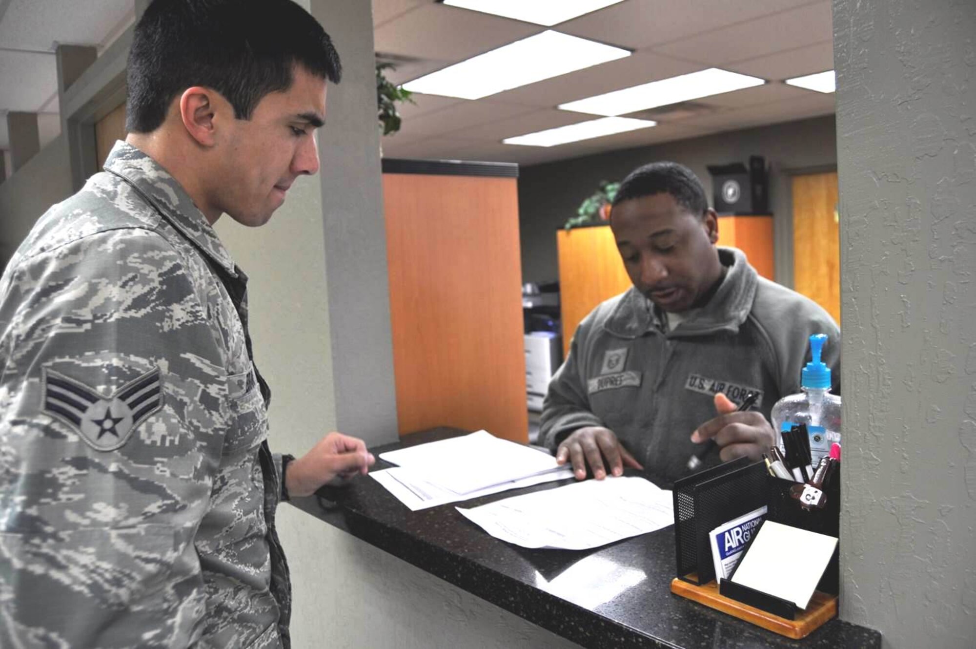 Master Sgt. Ken DuPree (right) helps a customer at the new customer service area inside the Wing headquarters building at the Nevada Air National Guard base in Reno.  USAF photo by Tech. Sgt. Rebecca Palmer RELEASED.
