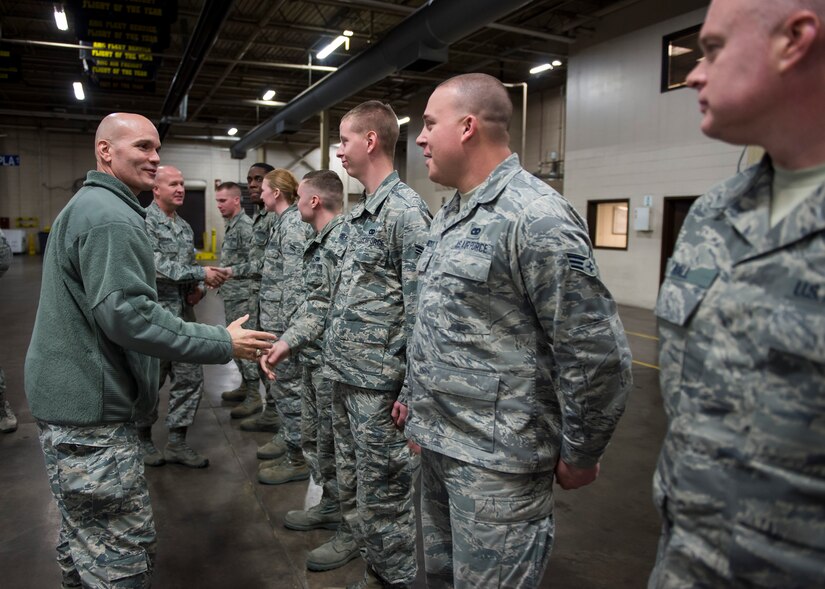 Lt. Gen. Carlton D. Everhart II, 18th Air Force commander, and Chief Master Sgt. Robert W. Rodewald, 18th Air Force command chief, congratulate Airmen from the 437th Aerial Port Squadron Port Dawg University, a program which streamlines the process of on-the-job training Jan. 8, 2015, at Joint Base Charleston S.C. While visiting JB Charleston, the general toured the 437th Maintenance Group, the 437th Aerial Port Squadron, the 437th Operations Support Squadron and other units across the wing to interact with the Airmen and civilians who work to provide precise, reliable airlift worldwide every day.  (U.S. Air Force photo/Senior Airman Jared Trimarchi)  