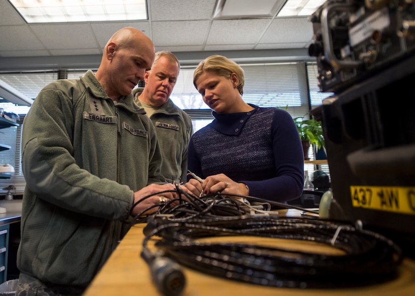 Lt. Gen. Carlton D. Everhart II, 18th Air Force commander, and Elizabeth White inspect a cable looking to be replaced on a C-17 Globemaster III Jan. 8, 2015, in the 437th Maintenance Group at Joint Base Charleston S.C. While visiting JB Charleston, the general toured the 437th Maintenance Group, the 437th Aerial Port Squadron, the 437th Operations Support Squadron and other units across the wing to interact with the Airmen and civilians who work to provide precise, reliable airlift worldwide every day.  White is a member of the 437th Maintenance Group. (U.S. Air Force photo/Senior Airman Jared Trimarchi)  