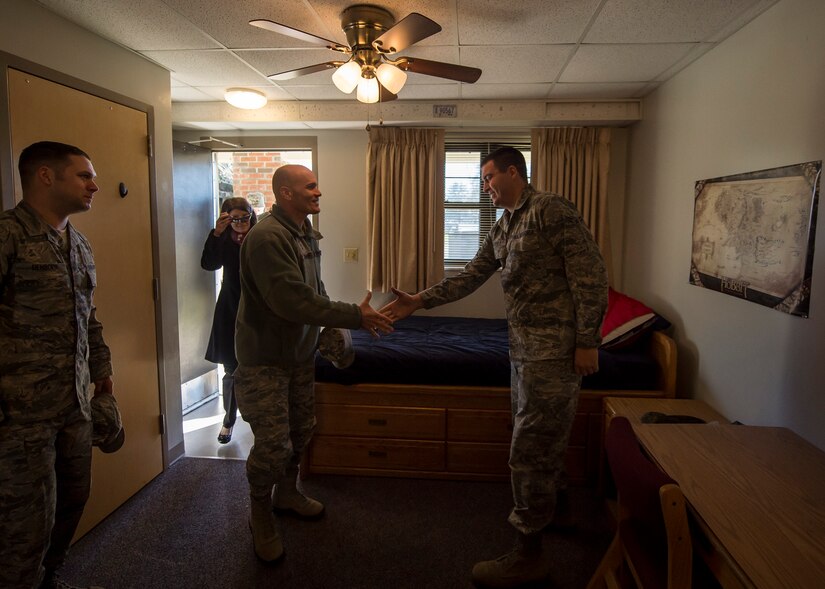 Lt. Gen. Carlton D. Everhart II, 18th Air Force commander, greets Airman 1st Class Taylor Bauer in a dormitory to get a feel for the quality of life provided to junior enlisted Airmen Jan. 8, 2015, at Joint Base Charleston S.C. While visiting JB Charleston, the general toured the 437th Maintenance Group, the 437th Aerial Port Squadron, the 437th Operations Support Squadron and other units across the wing to interact with the Airmen and civilians who work to provide precise, reliable airlift worldwide every day.  Bauer is a member of the 437th Maintenance Squadron Precision Measurement Equipment Laboratory. (U.S. Air Force photo/Senior Airman Jared Trimarchi)  