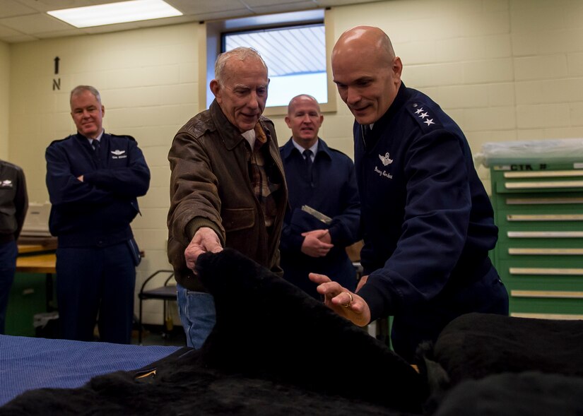 Lt. Gen. Carlton D. Everhart II, 18th Air Force commander, feels the texture of a C-17 Globemaster III seat cover that was handmade by Bobby Pierce (left) in the 437th Operations Support Squadron fabrication shop Jan. 8, 2015, at Joint Base Charleston S.C. While visiting JB Charleston, the general toured the 437th Maintenance Group, the 437th Aerial Port Squadron, the 437th Operations Support Squadron and other units across the wing to interact with the Airmen and civilians who work to provide precise, reliable airlift worldwide every day. Pierce is a member of the 437th Aircrew Flight equipment shop. (U.S. Air Force photo/Senior Airman Jared Trimarchi)  