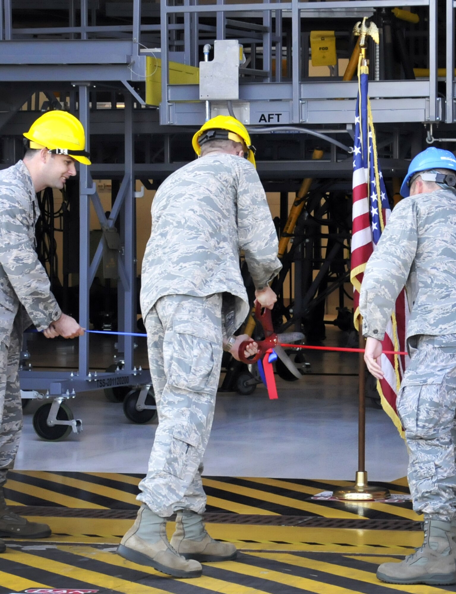 Col. Jeffrey Macrander, commander of the 920th Rescue Wing, cuts the ribbon on Hangar 630--the fixed-wing aircraft isochronal inspection (ISO) hangar of the 920th Rescue Wing, officially opening it for business. The hangar was part of a $4 million multiyear project to expand the structure by roughly 10,000 square feet (from the building's original 17,000) in order to fully enclose the wing's HC-130P/N refueling aircraft. (photo/Senior Airman Natasha Dowridge)