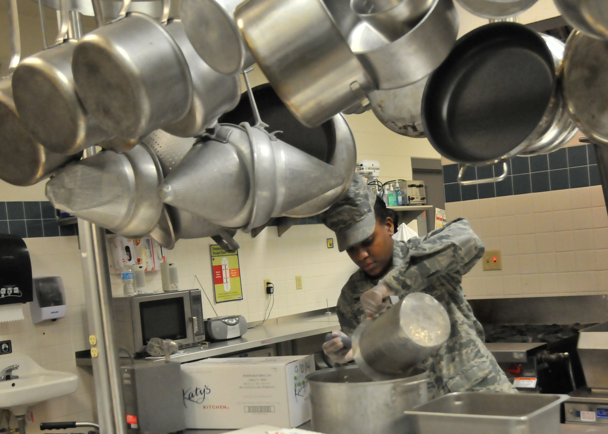 Senior Airman Shaundra Smith, a Services specialist, 153rd Airlift Wing, Wyoming Air National Guard, prepares a black-pepper gravy for the breakfast meal at the 153 AW dining facility Jan. 11, 2015 in Cheyenne, Wyoming. Services airmen served brunch in place of lunch to Guard members and guests. (U.S. Air National Guard photo by Master Sgt. Leisa Grant/Released)