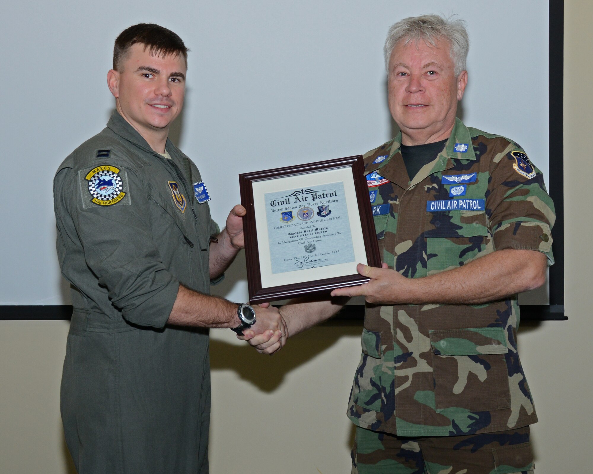 John Clark, Commander of Civil Air Patrol Group 6, presents Capt. Scott Morris, 93rd Fighter Squadron pilot, with a certificate of appreciation at Homestead Air Reserve Base, Fla., Jan. 10. Morris led a tour introducing the young cadets to some in-depth information on the process on becoming a pilot. (U.S. Air Force photo/Senior Airman Nicholas Caceres)