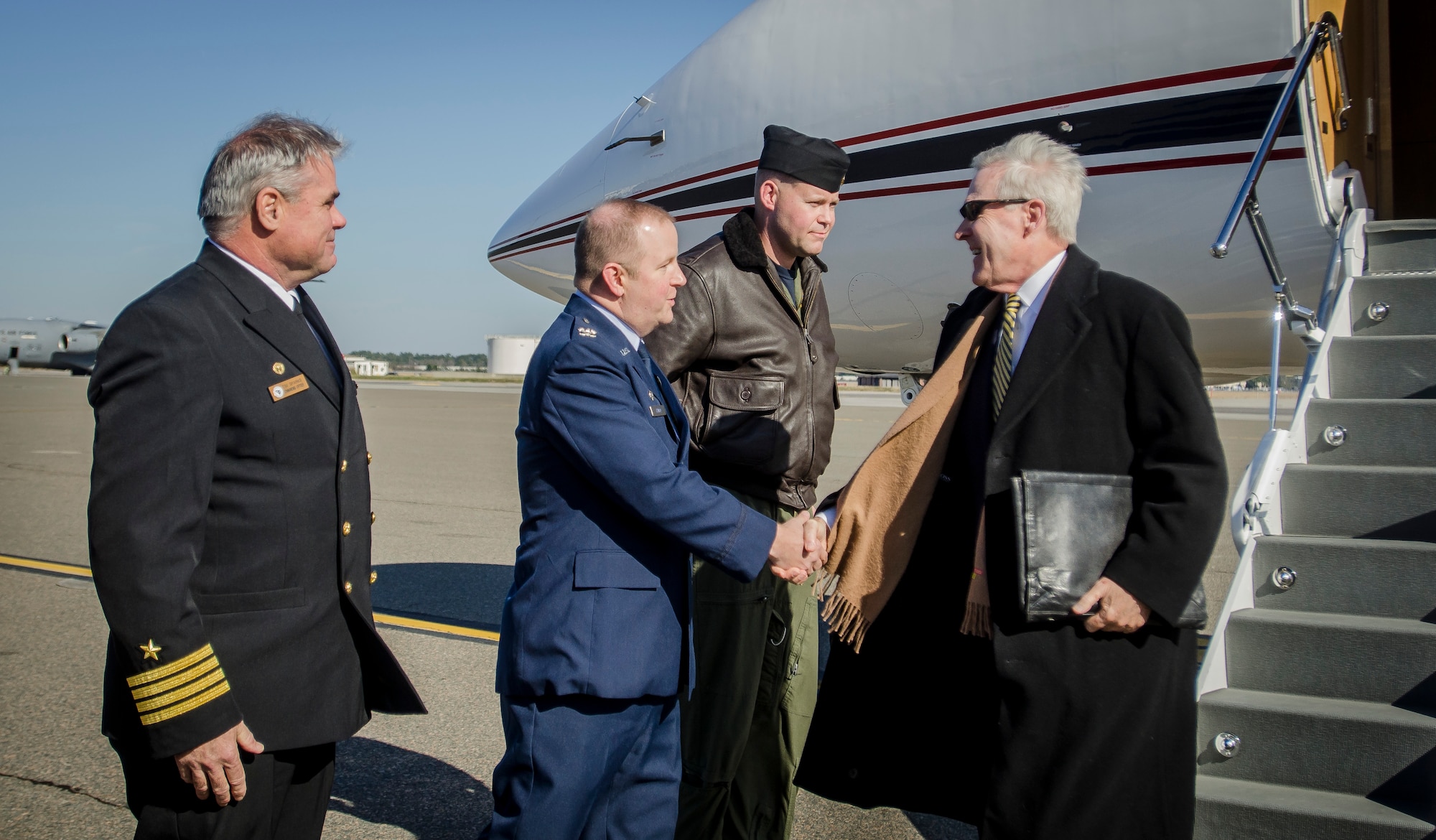 Colonel Jeffrey DeVore, Joint Base Charleston commander, and CAPT. Timothy Sparks, Joint Base Charleston deputy commander, welcomes Ray Mabus, Secretary of the Navy, Jan. 9, 2014, to JB Charleston – Air Base, S.C. Mabus was visiting Charleston to recognize the sixth ship in the U.S. fleet designated with the Charleston name. The U.S. littoral combat ship will be built in Mobile, Ala., and is scheduled for delivery in December 2017. (U.S. Air Force photo / Senior Airman Tom Brading)