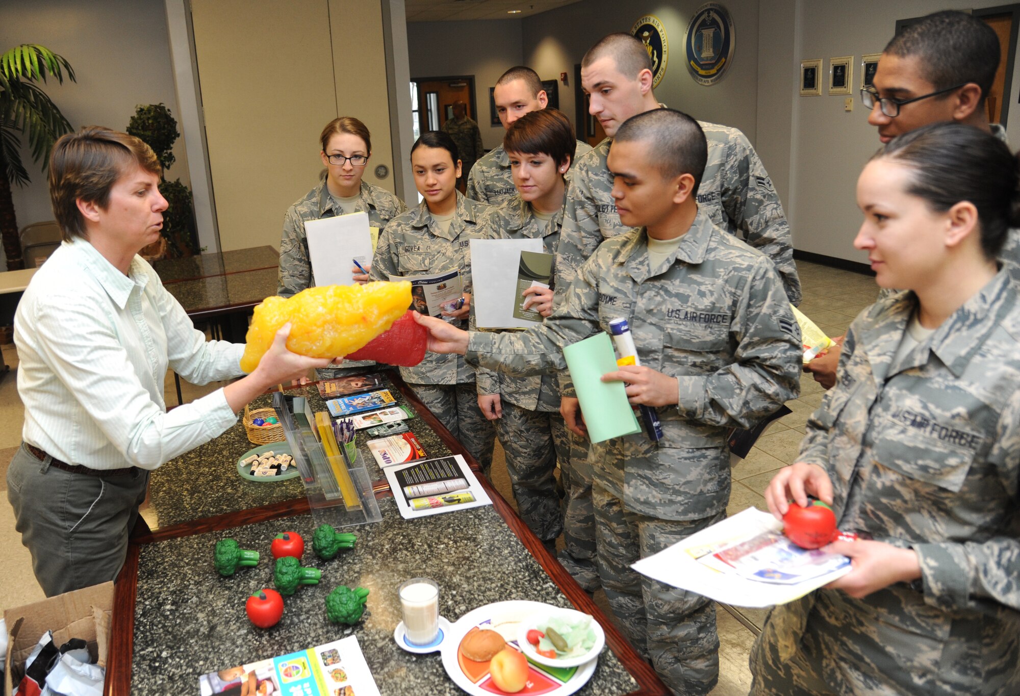 Terri Jordan talks to Airman 1st Class Aristotle Aboyme, 335th Training Squadron, about the difference between a mass of fat and a mass of muscle during a non-prior service student in-processing session Jan. 9, 2015, at the Levitow Training Support Facility, Keesler Air Force Base, Miss. Jordan is the 81st Aerospace Medicine Squadron health promotion coordinator and Aboyme is a trainee in the 335th Training Squadron.  Jordan provides information to the Keesler community on healthy eating and conducts a monthly healthy weight class.   Her New Year’s resolution is to stay consistent with exercise. (U.S. Air Force photo by Kemberly Groue)
