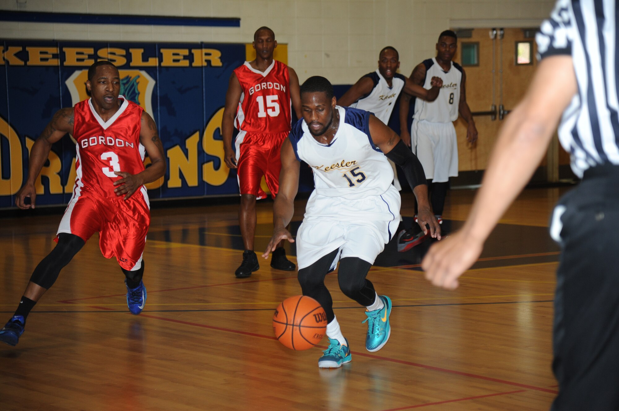 Jamie Guice, Keesler, gains control of the ball as Chedric McElderry, Fort Gordon, Ga., closes in during the men’s varsity basketball competition Jan. 10, 2015, at the Blake Fitness Center, Keesler Air Force Base, Miss. Fort Gordon defeated Keesler, 89-67.  (U.S. Air Force photo by Kemberly Groue)