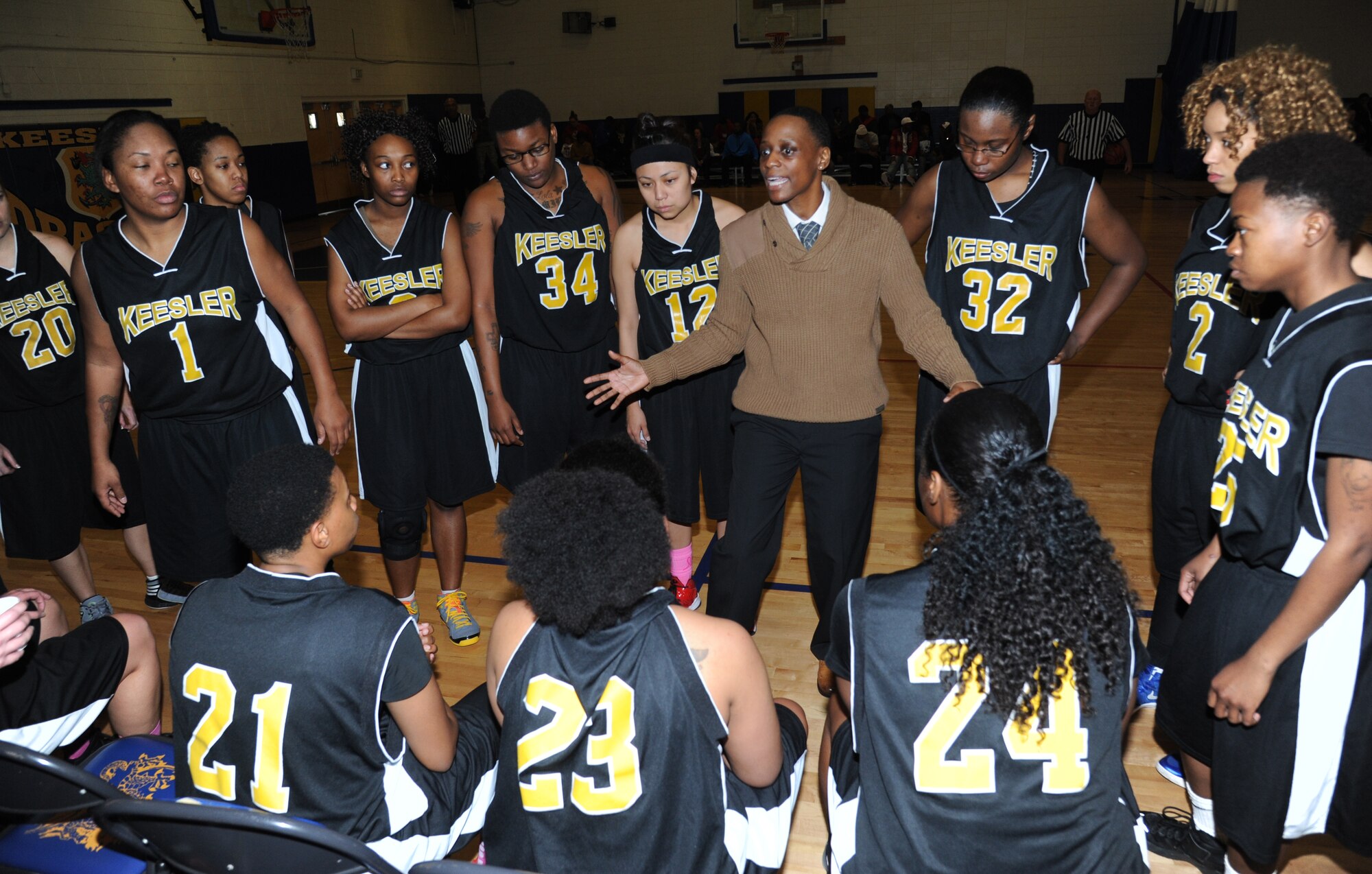 Karen Moore, Keesler’s head coach, talks strategy with her players during a  timeout at the women’s varsity basketball competition against Fort Gordon, Ga., Jan. 10, 2015, at the Blake Fitness Center, Keesler Air Force Base, Miss. Keesler defeated Fort Gordon, 66-61.  (U.S. Air Force photo by Kemberly Groue)