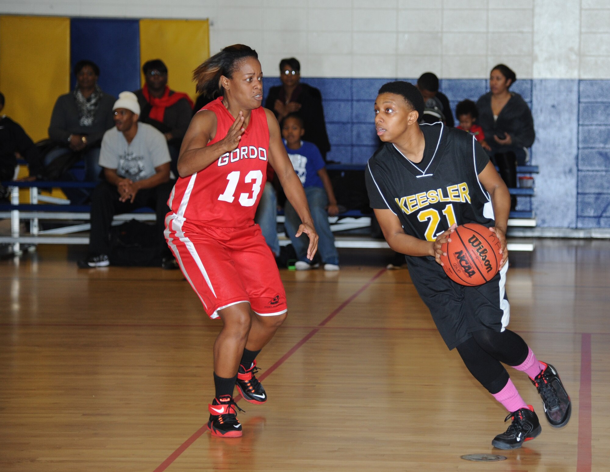 Sharon Jackson, Fort Gordon, Ga., plays defense as Ashlee Johnson, Keesler, looks to make a pass during the women’s varsity basketball competition Jan. 10, 2015, at the Blake Fitness Center, Keesler Air Force Base, Miss. Keesler defeated Fort Gordon, 66-61.  (U.S. Air Force photo by Kemberly Groue)