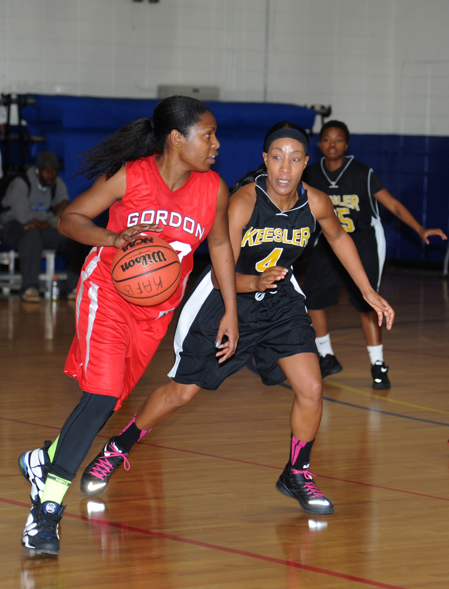 Aisha Brown, Fort Gordon, Ga., dribbles the ball around Tomeika Frazier, Keesler during the women’s varsity basketball competition Jan. 10, 2015, at the Blake Fitness Center, Keesler Air Force Base, Miss. Keesler defeated Fort Gordon, 66-61.  (U.S. Air Force photo by Kemberly Groue)