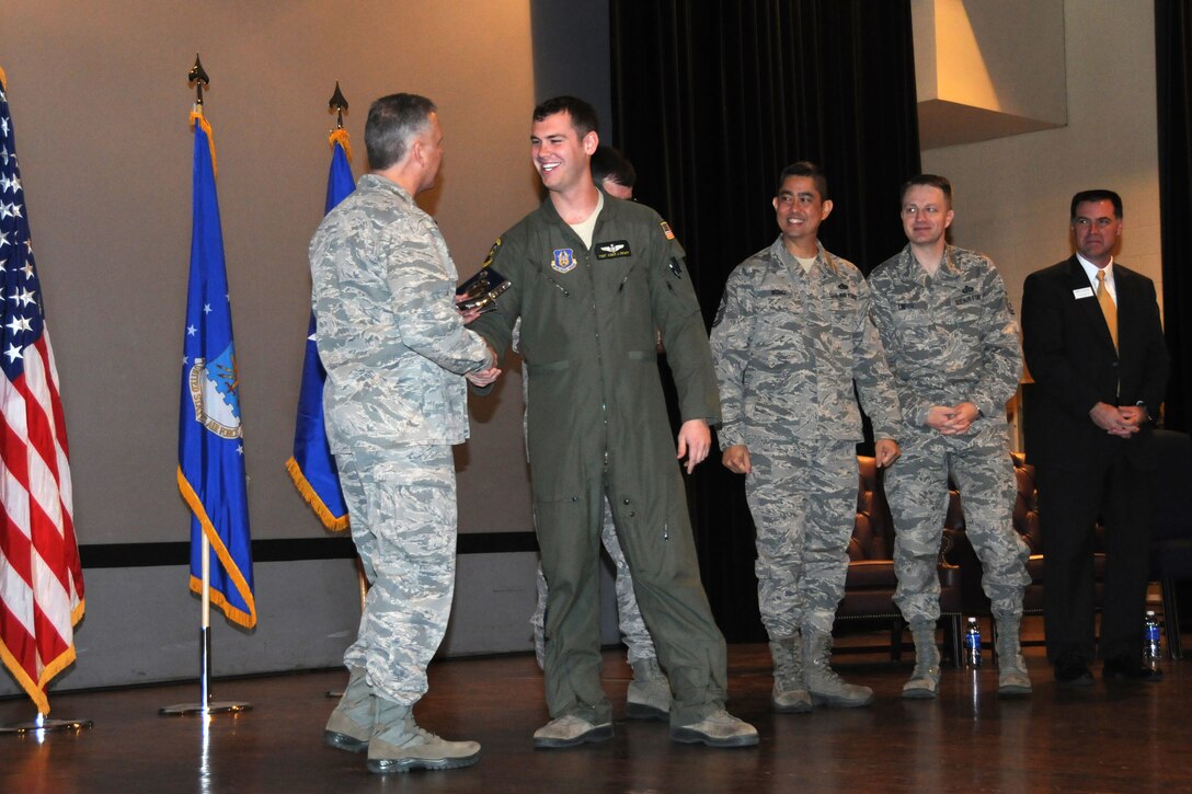 Tech. Sgt. Adam Craft, 77th Air Refueling Squadron boom operator, receives the 916th Air Refueling Wing NCO of the Year award during a ceremony at Seymour Johnson Air Force Base, Jan. 10, 2015. The award was presented by Brig. Gen. John Flournoy Jr., 4th Air Force commander, who was joined on stage by Col. Gregory Gilmour, 916th ARW commander; Chief Master Sgt. Brian Wong, 4th AF command chief; Chief Master Sgt. James Loper, 916th ARW command chief; and Mr. Scott Stevens, Goldsboro city manager and 916th ARW honorary commander. (USAF photo by Tech. Sgt. Scotty Sweatt, 916ARW/PA)